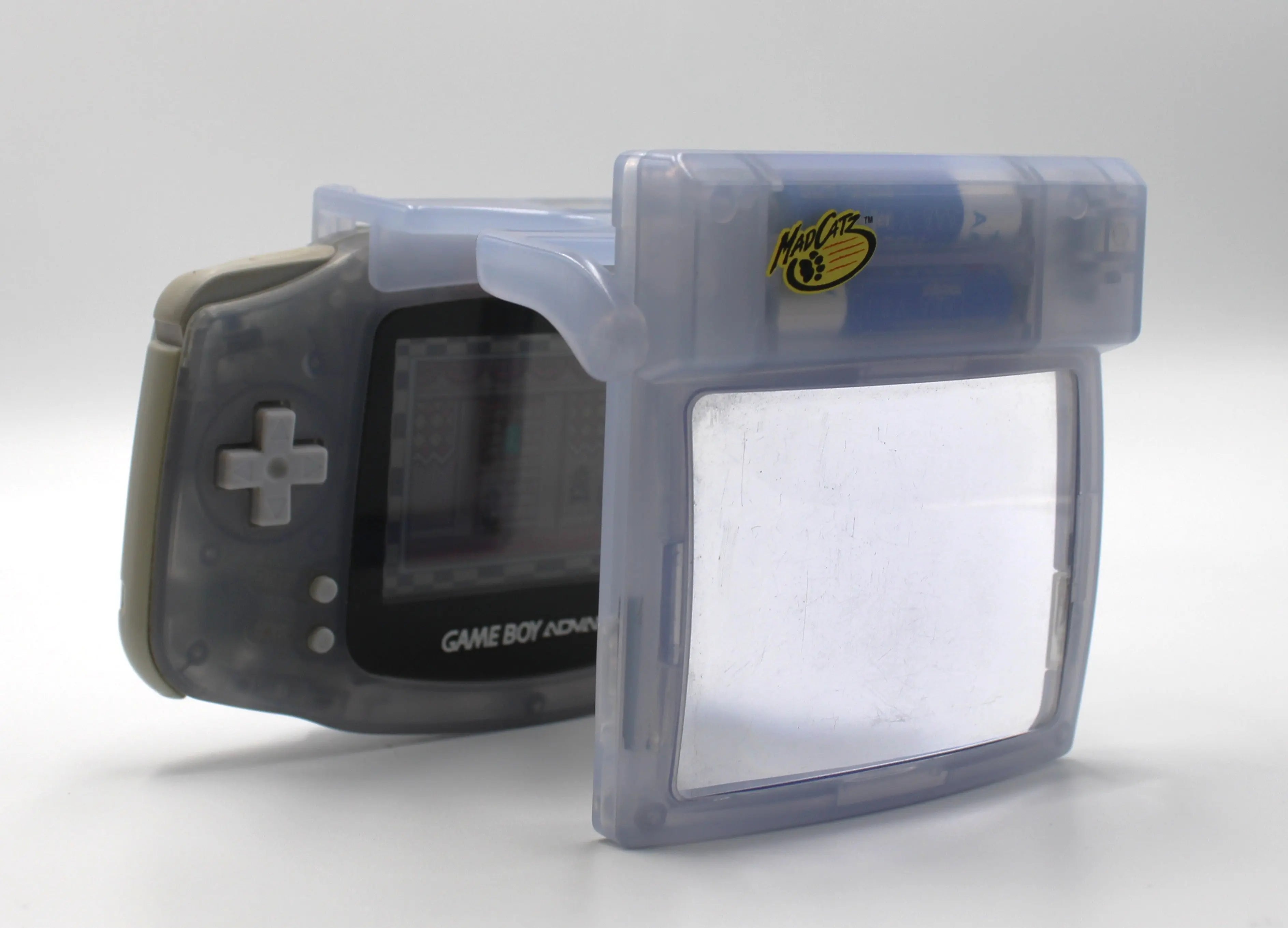 Pre-owned Glacier Ice Nintendo Game Boy Advance (GBA) Mad Catz Light & Screen Magnifier. Picture of side attached to a gba.
