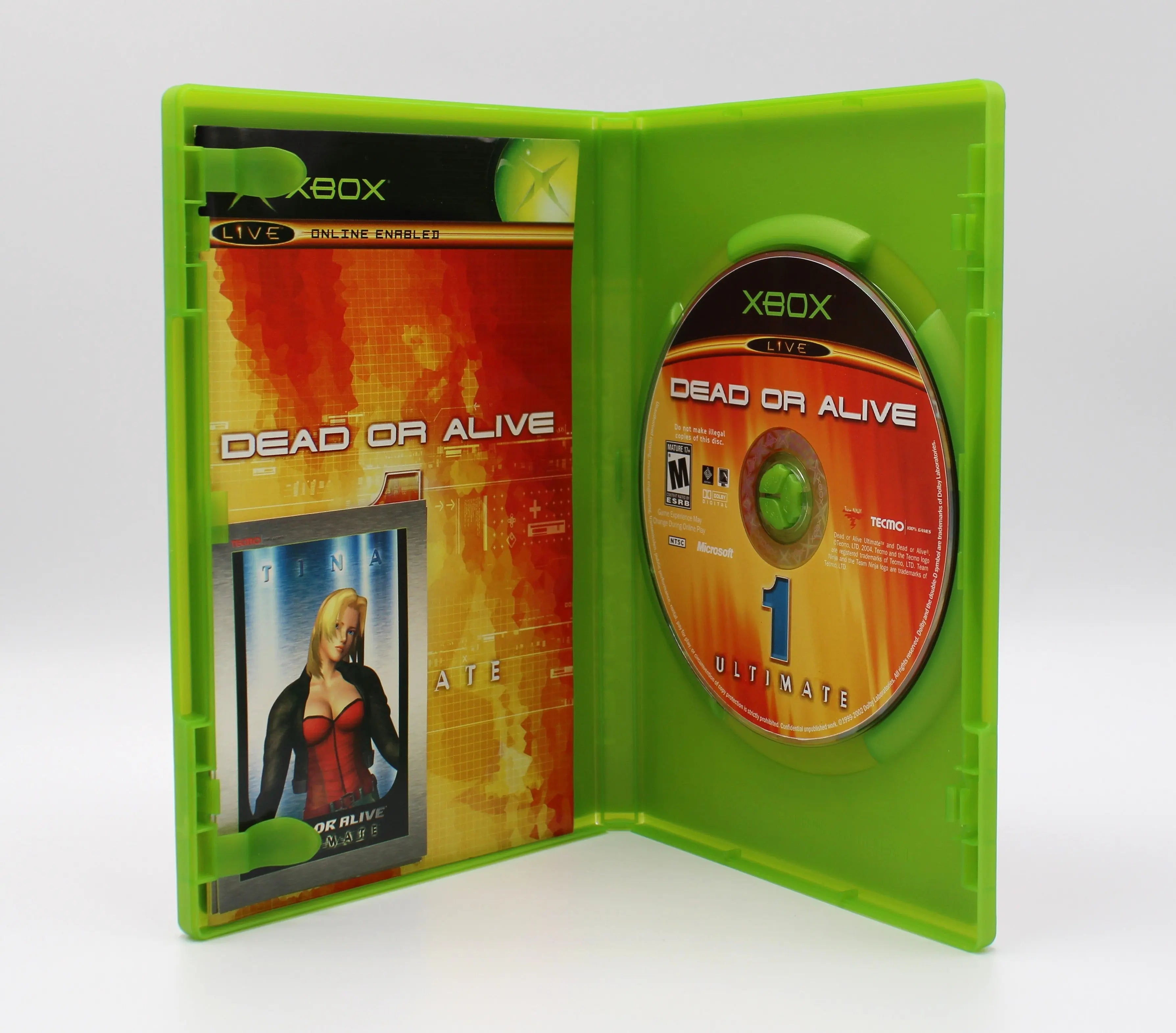 Open case view of Dead or Alive 1 for Microsoft Xbox Original NTSC-U, showing manual placement, Tina card, and game disc secured in tray.