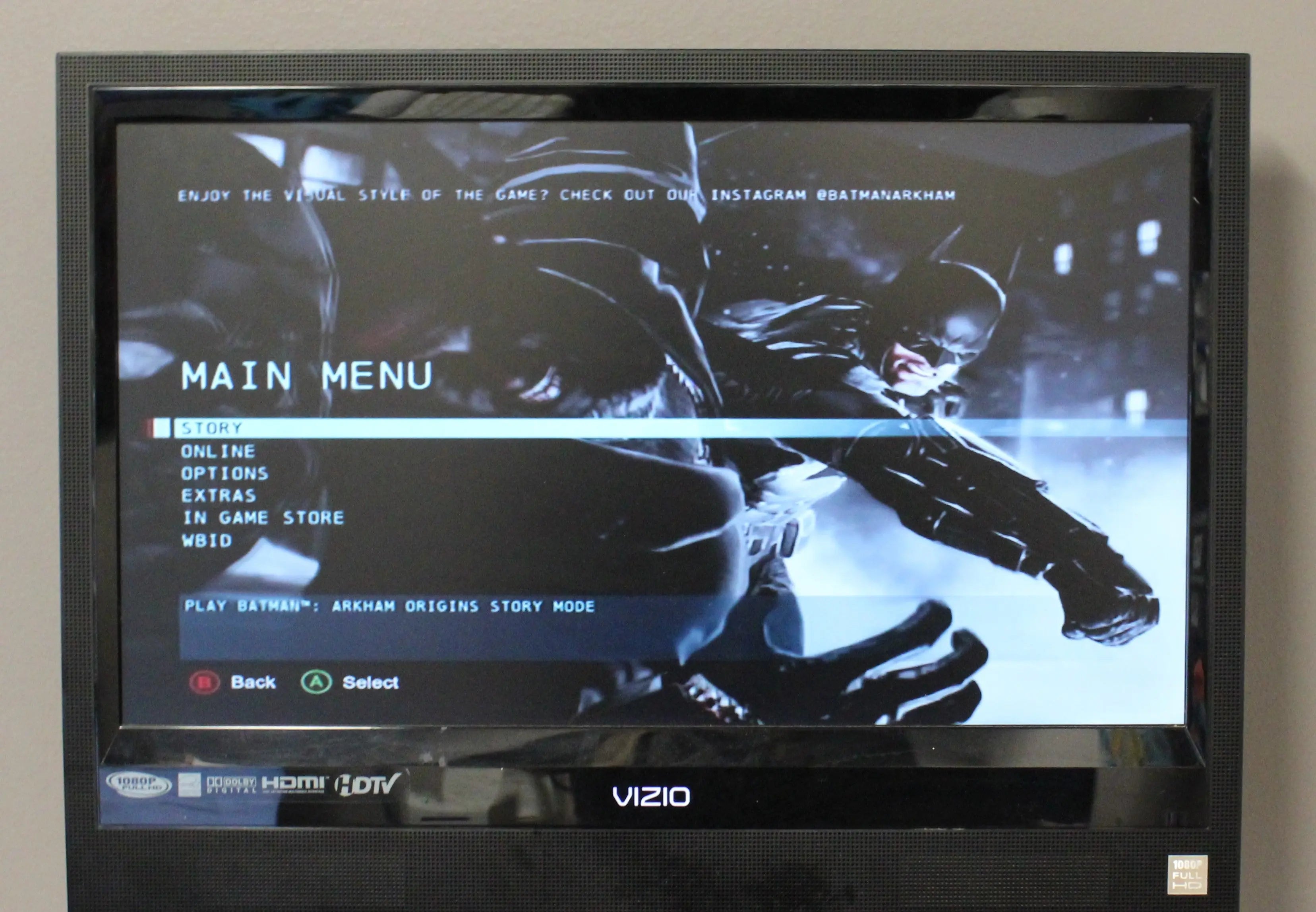 Gameplay screenshot image of Batman: Arkham Origins for Microsoft Xbox 360 NTSC-U, showing in-game action and visual style on main menu with options.