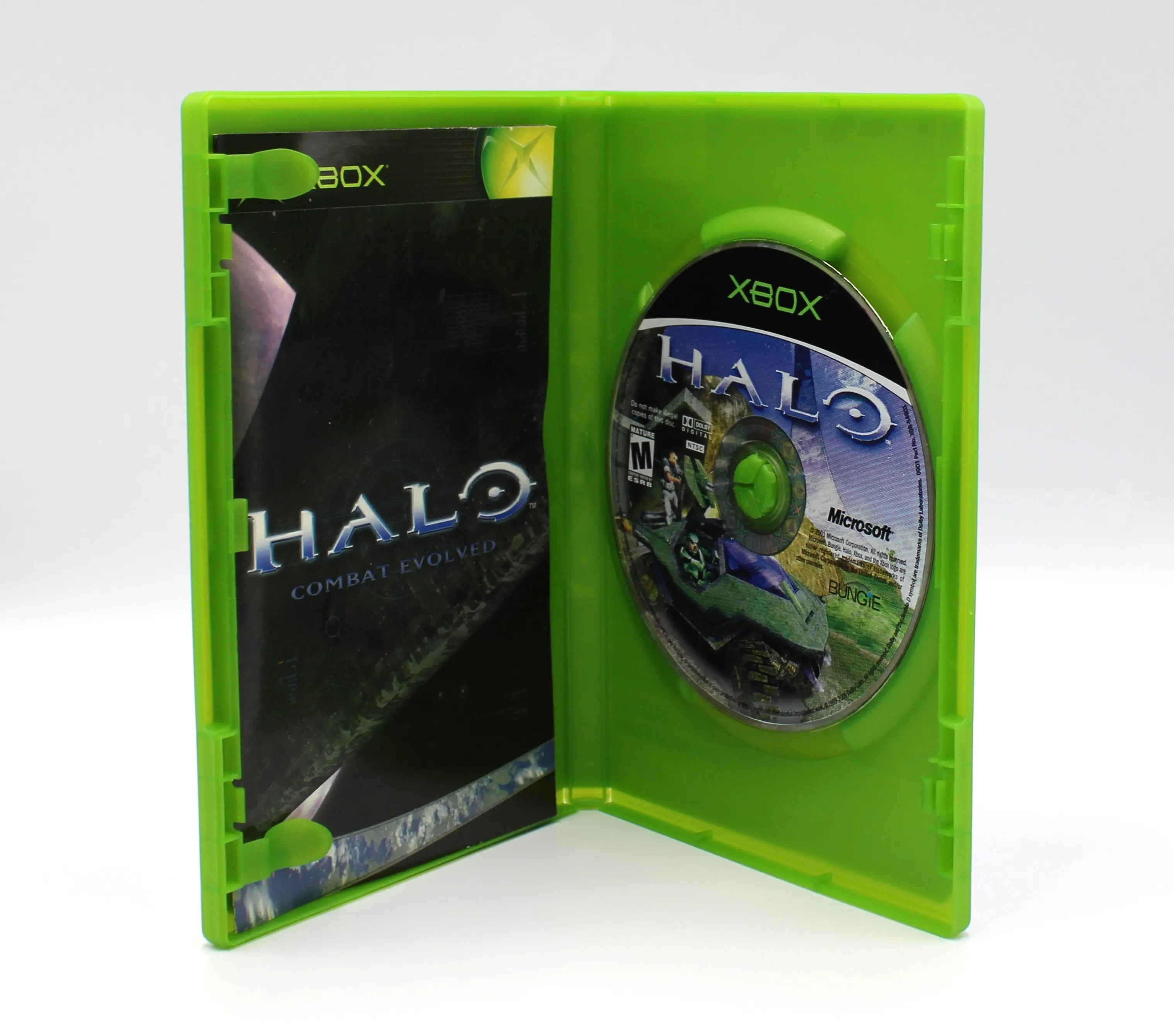 Open case view of Halo: Combat Evolved for Microsoft Xbox Original NTSC-U, showing manual placement and game disc secured in tray.