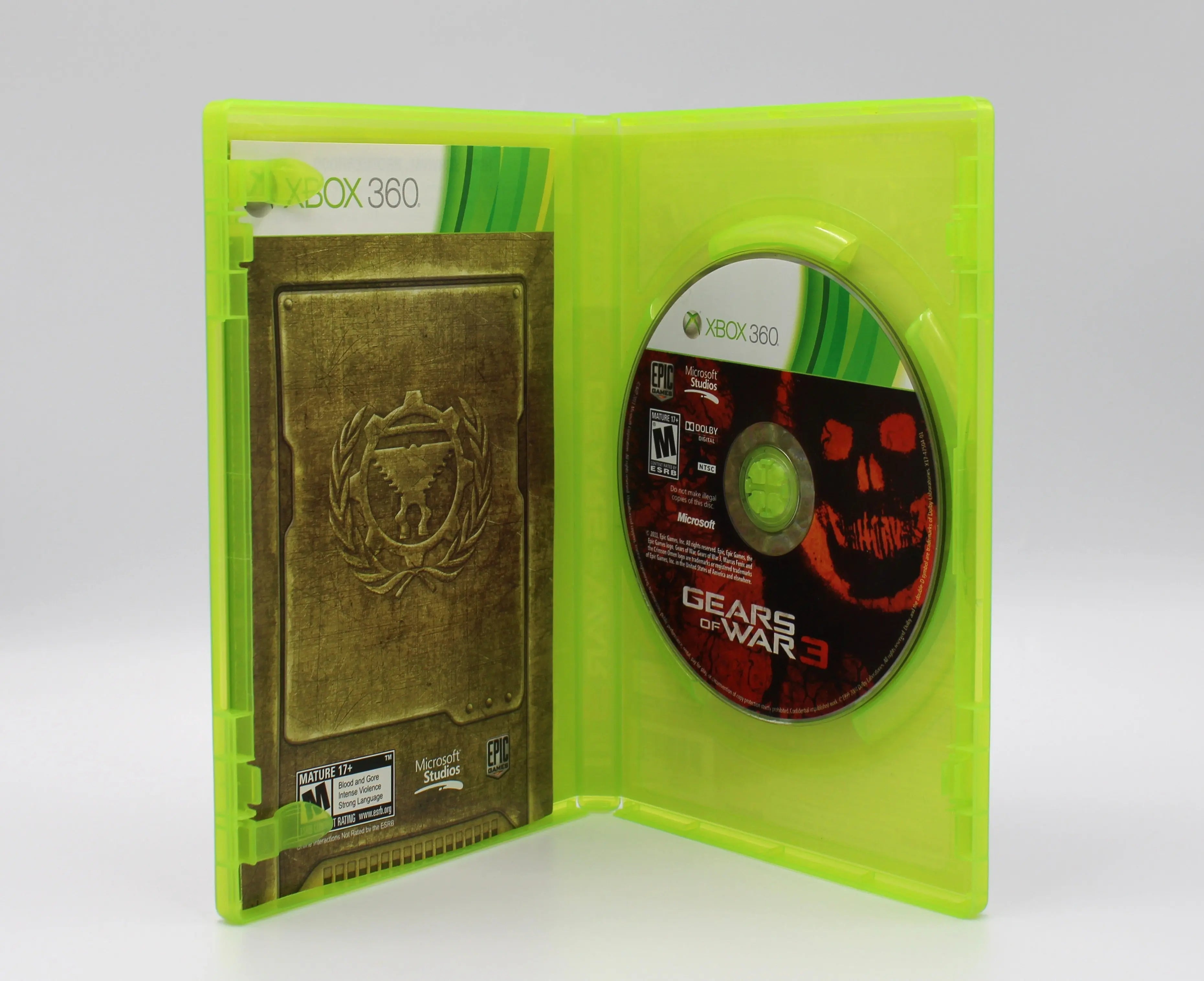 Open case view of Gears of War 3 for Microsoft Xbox 360 NTSC-U, showing manual with no stickers and game disc secured in tray.