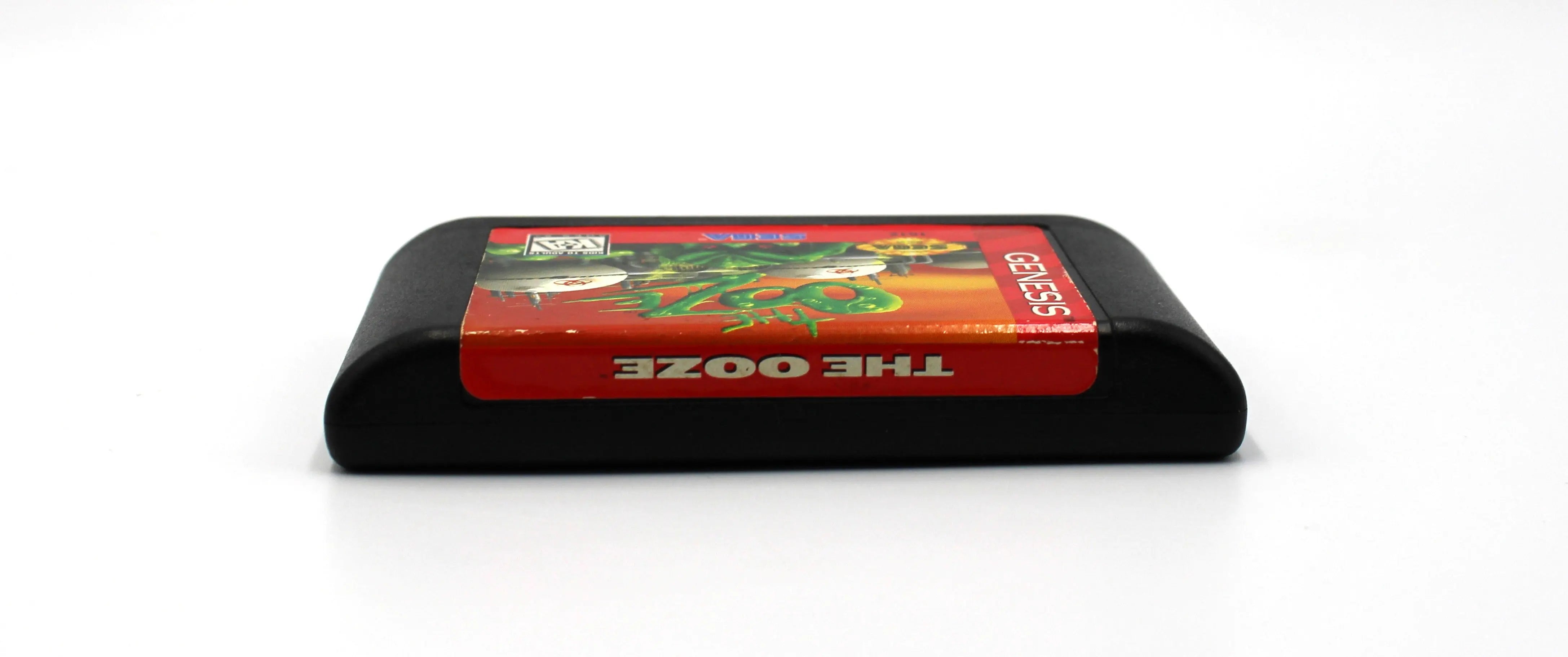 Top label view of cartridge for The Ooze for Sega Genesis. 1995. NTSC-U Authentic Video Game Cartridge. See picture of game cartridge top label.