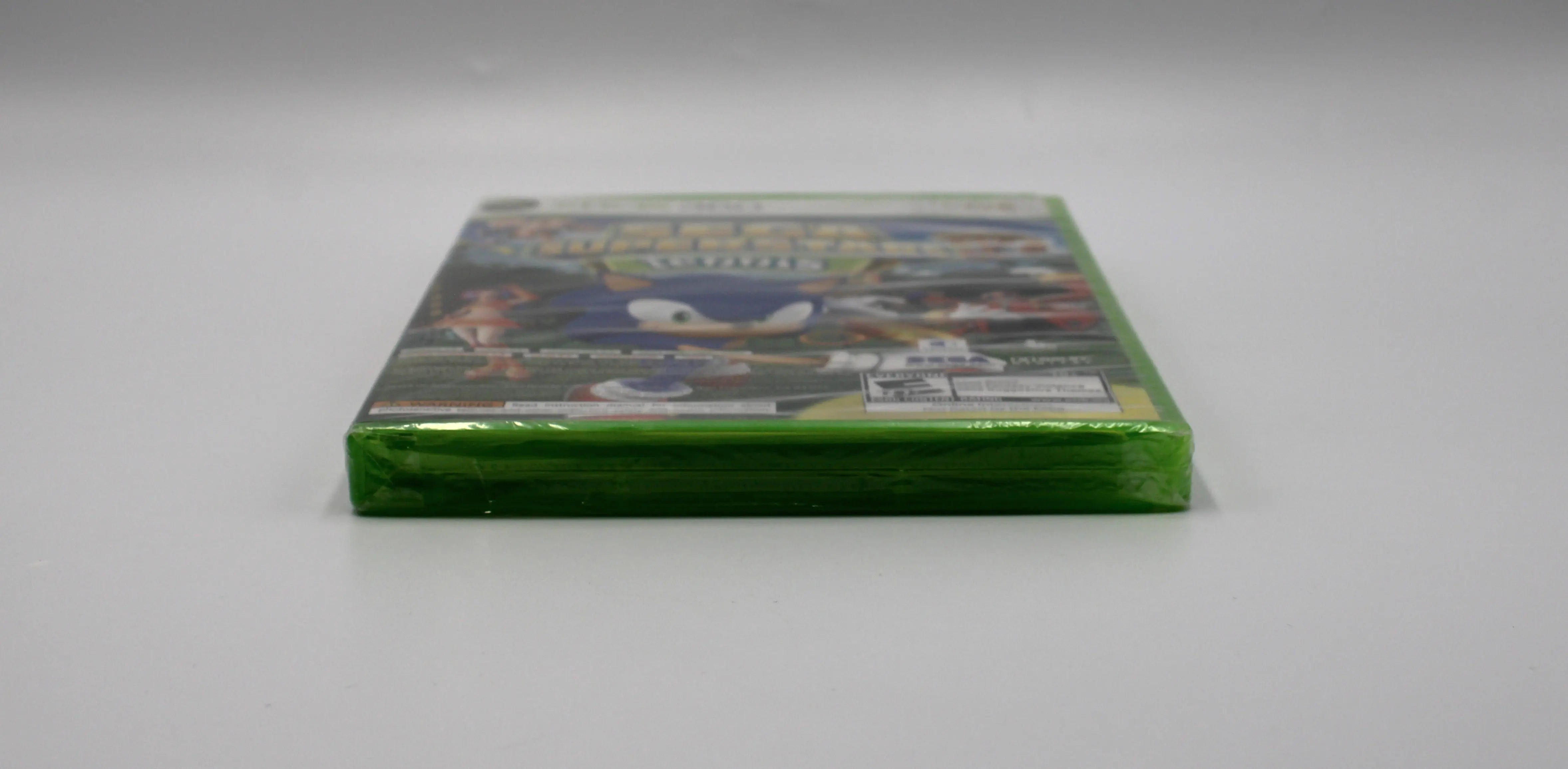 Bottom view of Sega Superstars Tennis & Arcade Compilation for Microsoft Xbox 360 NTSC-U sealed game case, showing sealed edges and factory wrap condition.