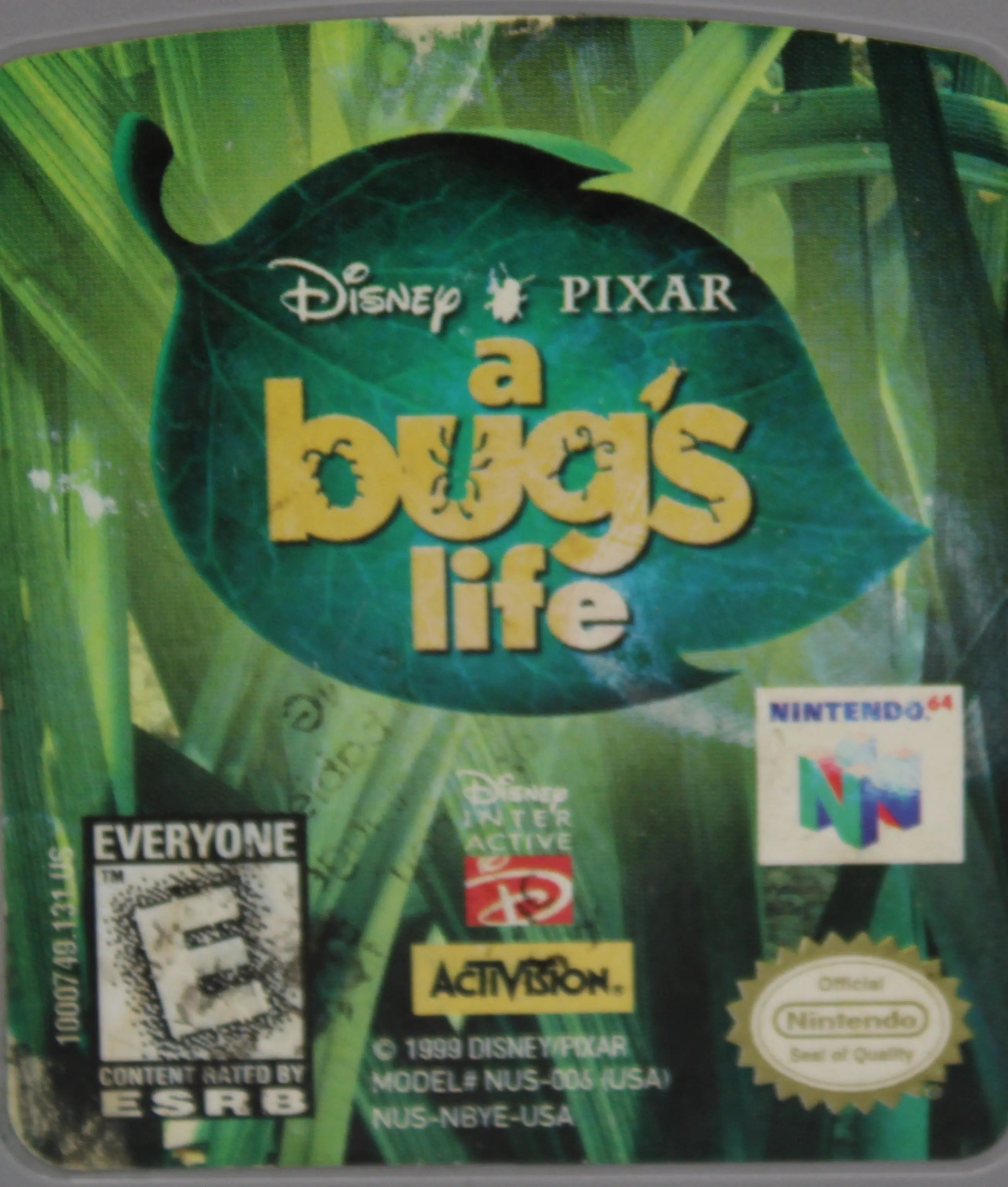 Middle of front label view Disney's A Bug's Life for Nintendo 64, N64. Released in 1999. See picture of middle of front label showing fading and stains from use and age.
