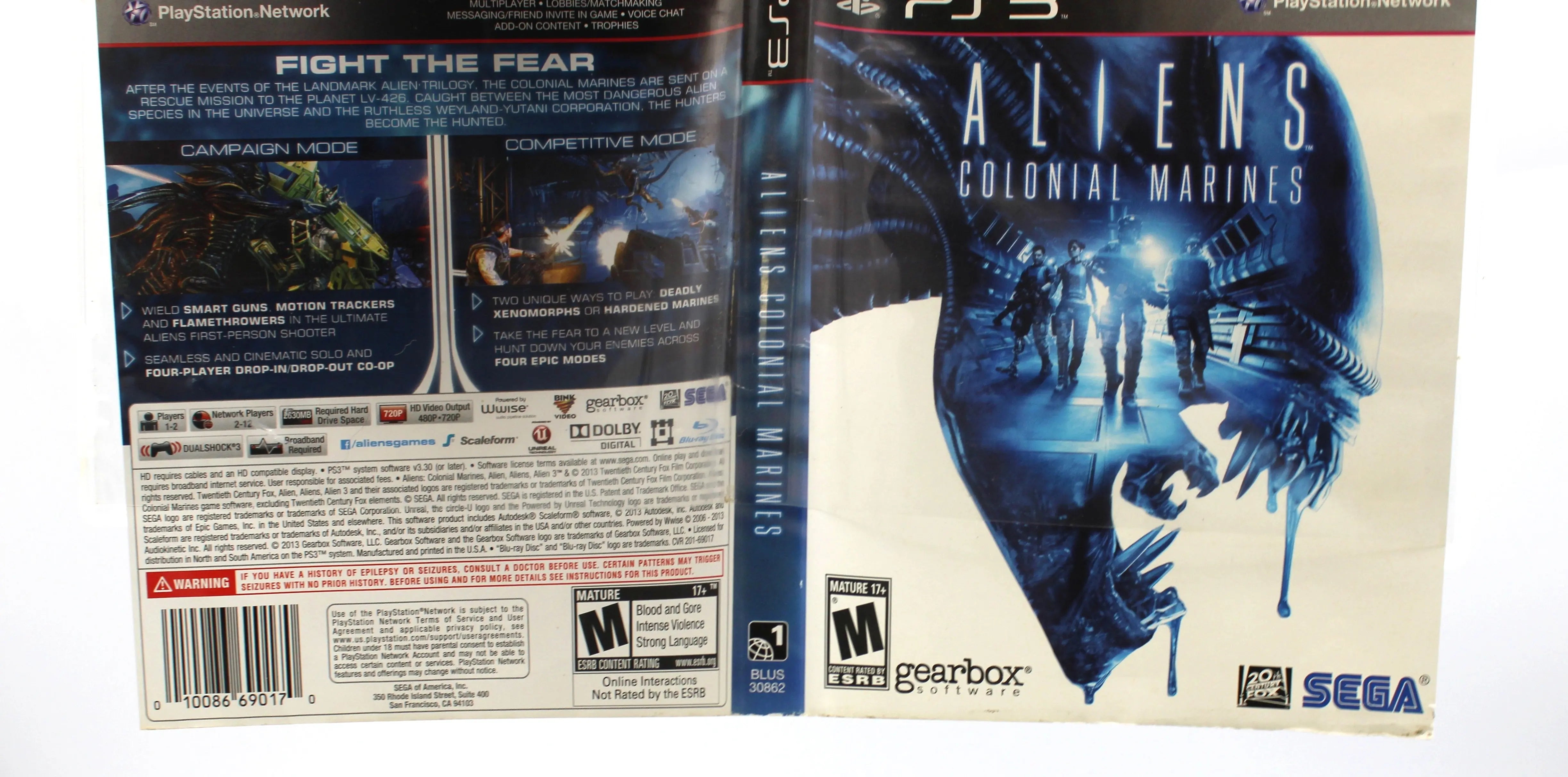 Exterior close up shot of the bottom edge of the case for Aliens: Colonial Marines for Sony PlayStation 3 PS3 – CIB with manual (2013) NTSC‑U, highlighting minor scuffing , fading, and wear to the OEM artwork.