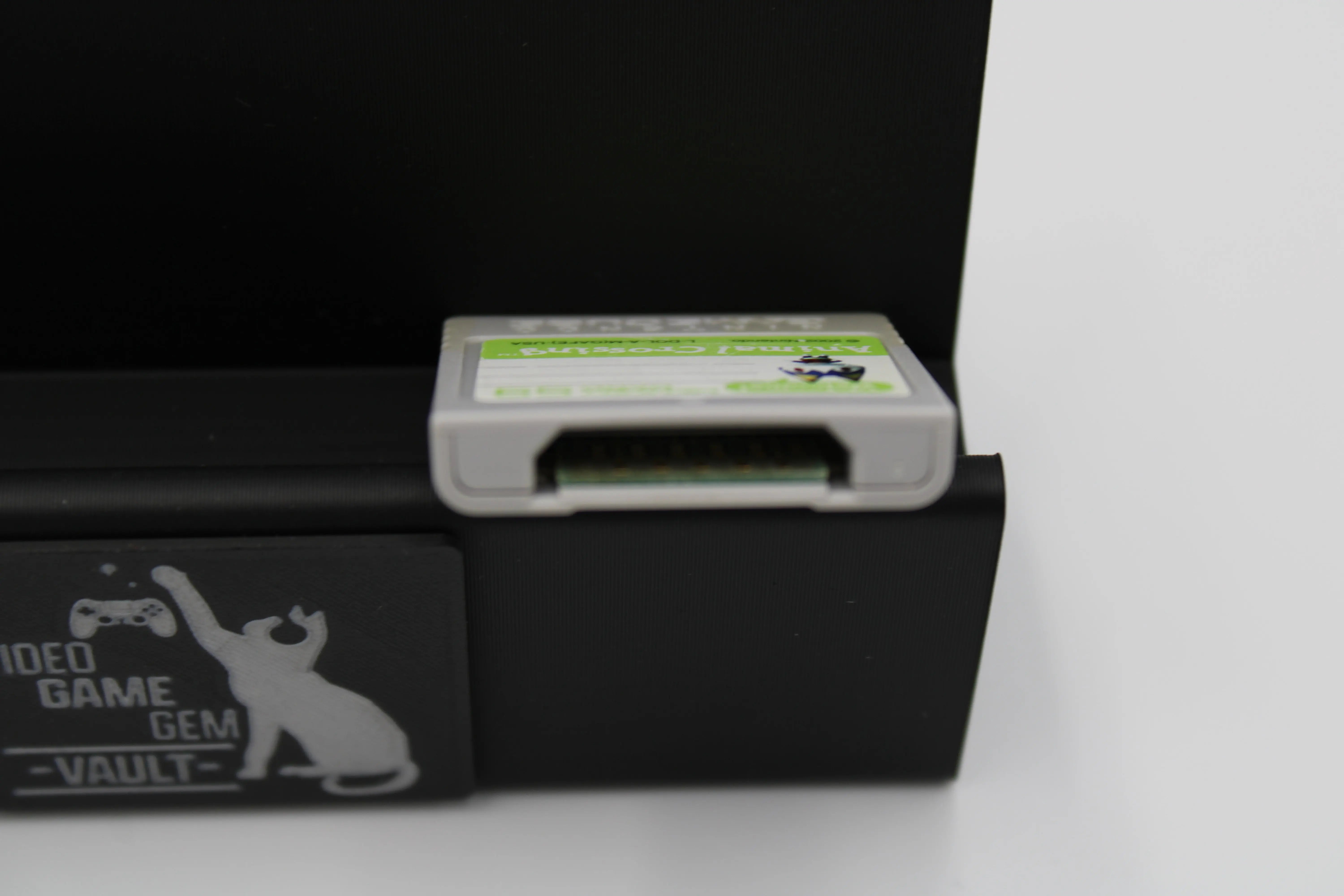 Top image of 2002 released NTSC-U of OEM Animal Crossing Memory Card for Nintendo GameCube – 59 Blocks (DOL-008). Displaying authentic grey Animal Crossing memory card highlighting the top to show a cleaned and refurbished memory card.