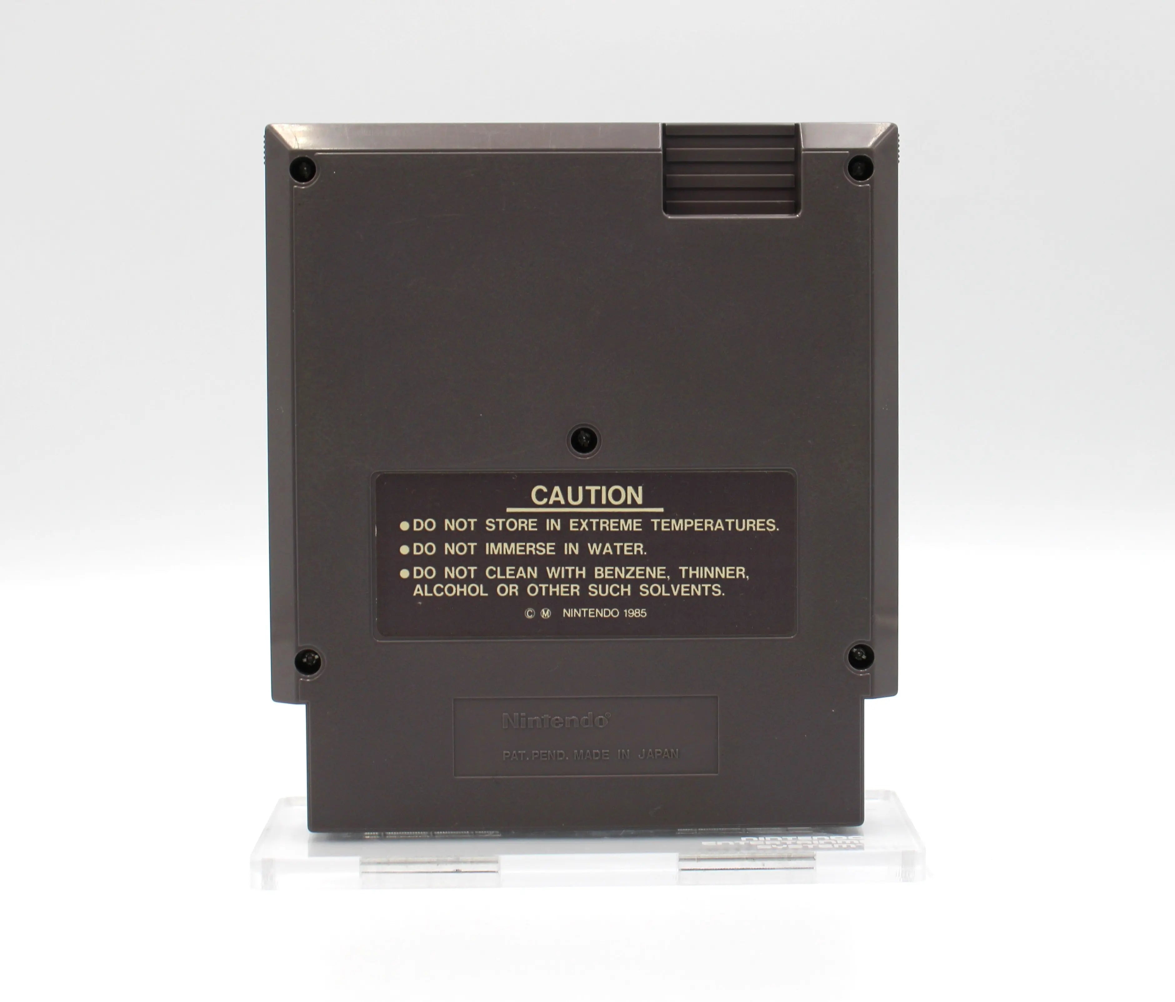 Back image of Commando for Nintendo NES (1986), showing cartridge shell, screw pattern, and authenticity details. Stamped.