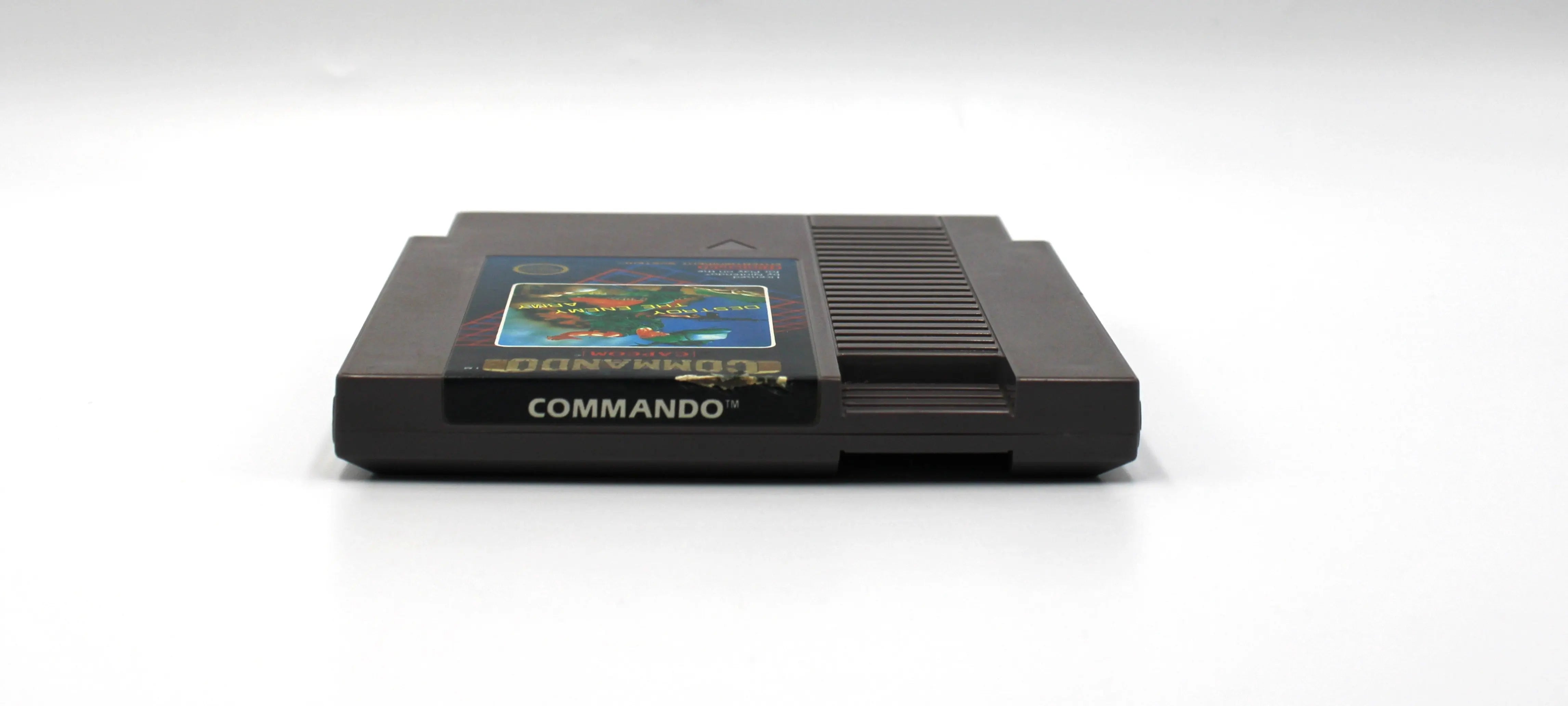 Top label image of Commando for Nintendo NES (1986), showing cartridge spine label for collector reference.