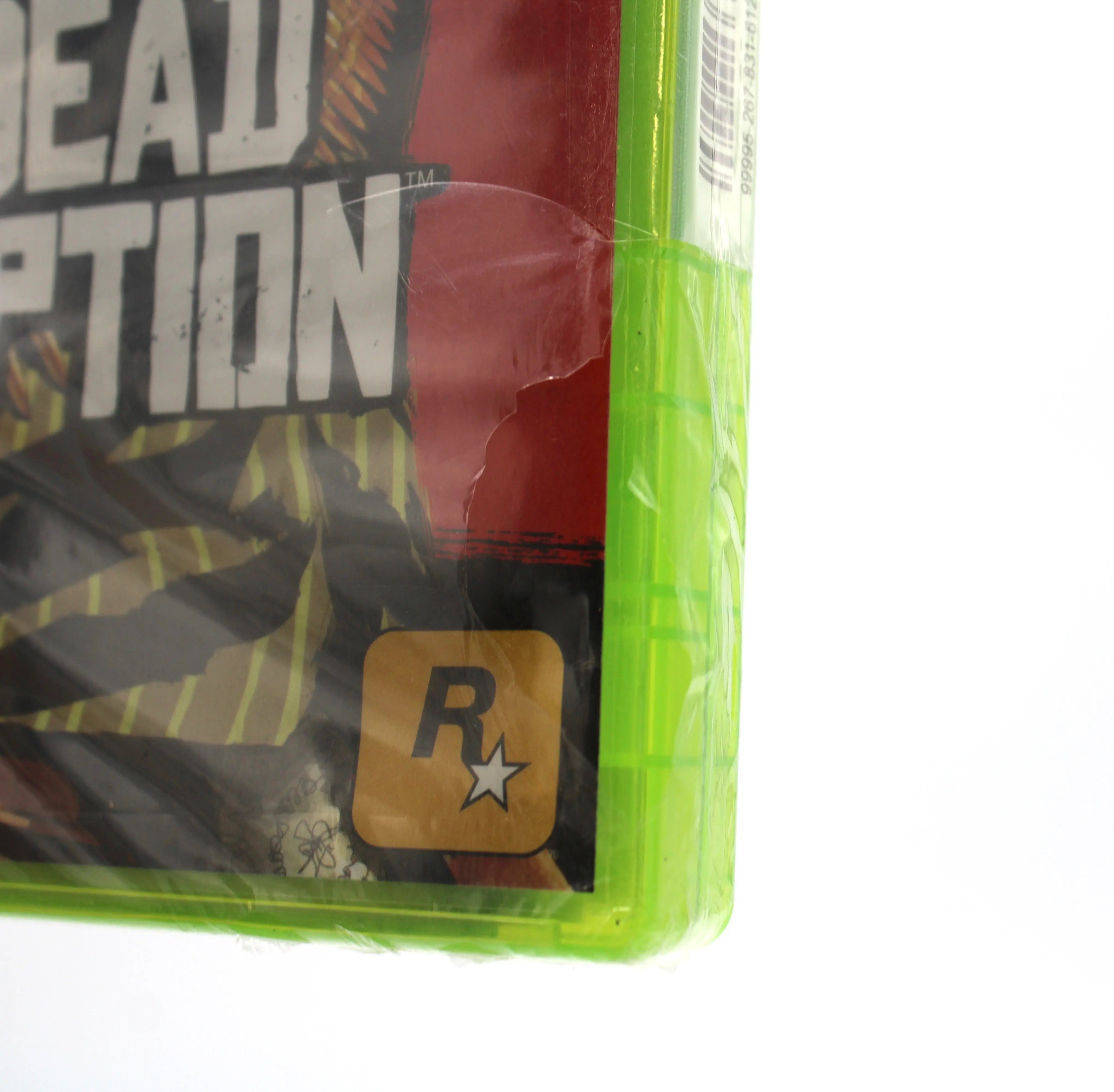 View of bottom of front of case of Red Dead Redemption for Microsoft Xbox 360 NTSC-U sealed Platinum Hits game case, showing tear to bottom right of front of case.