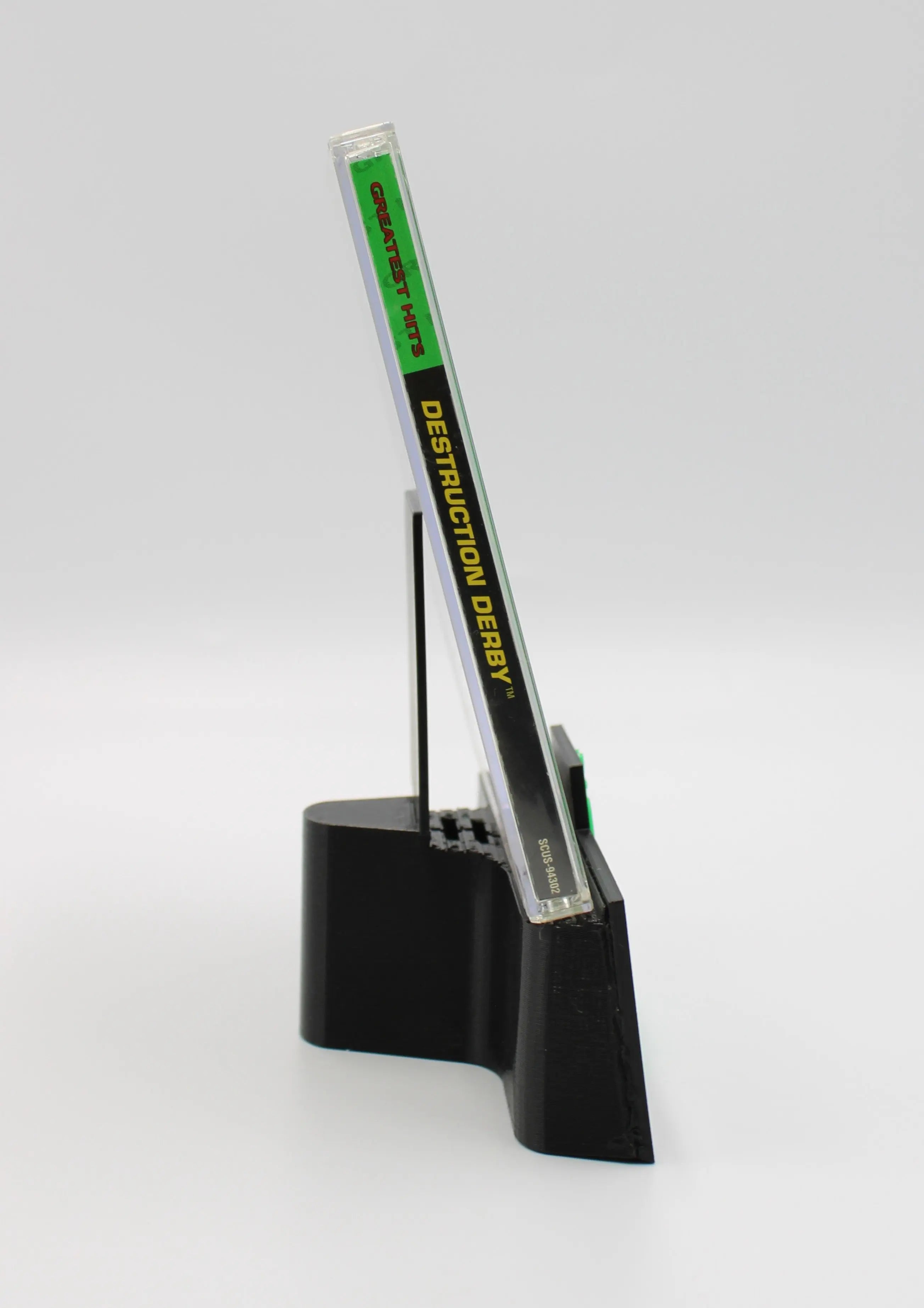 Opening side spine view of Destruction Derby for Sony PlayStation 1 PS1 NTSC-U Greatest Hits Edition game case, showing title text and case edge details.