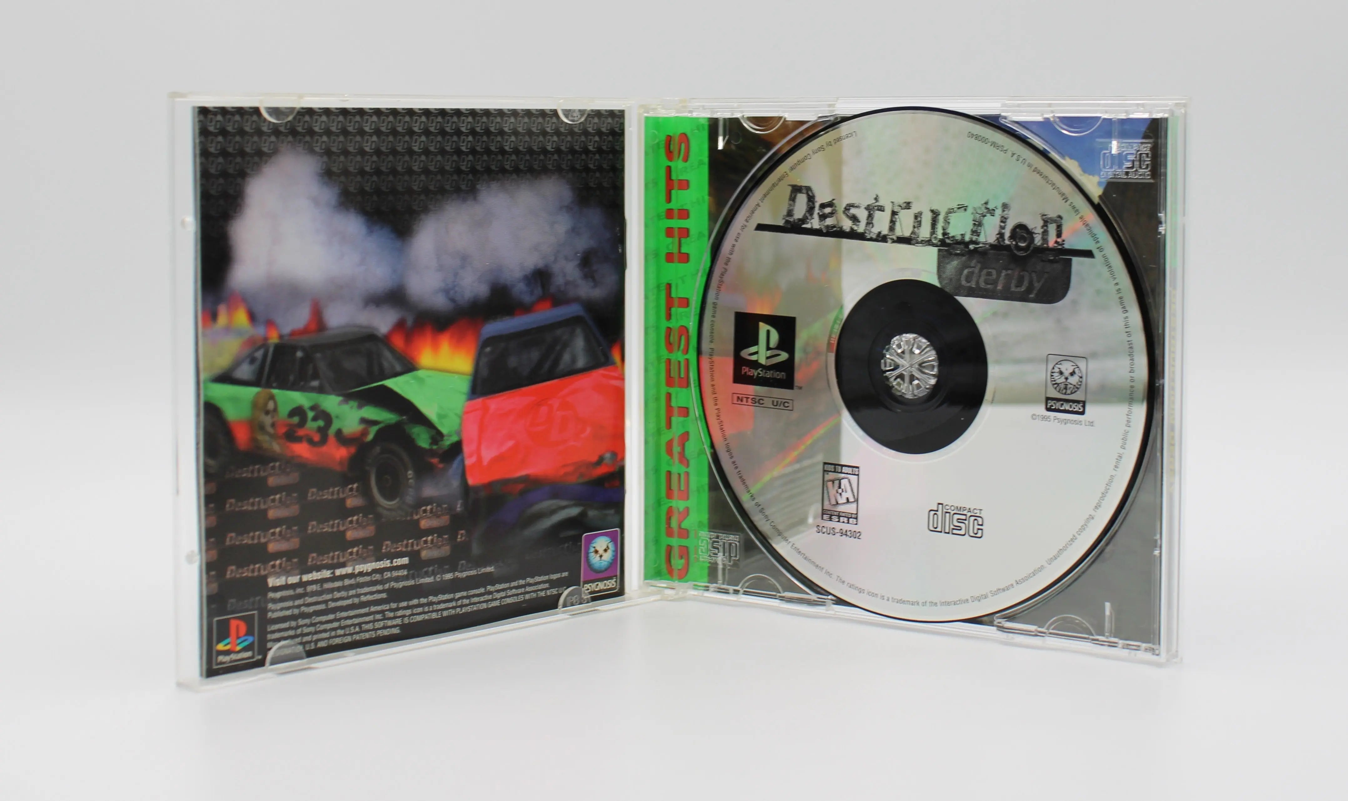 Open case view of Destruction Derby for Sony PlayStation 1 PS1 NTSC-U Greatest Hits Edition, showing manual placement and game disc secured in tray.