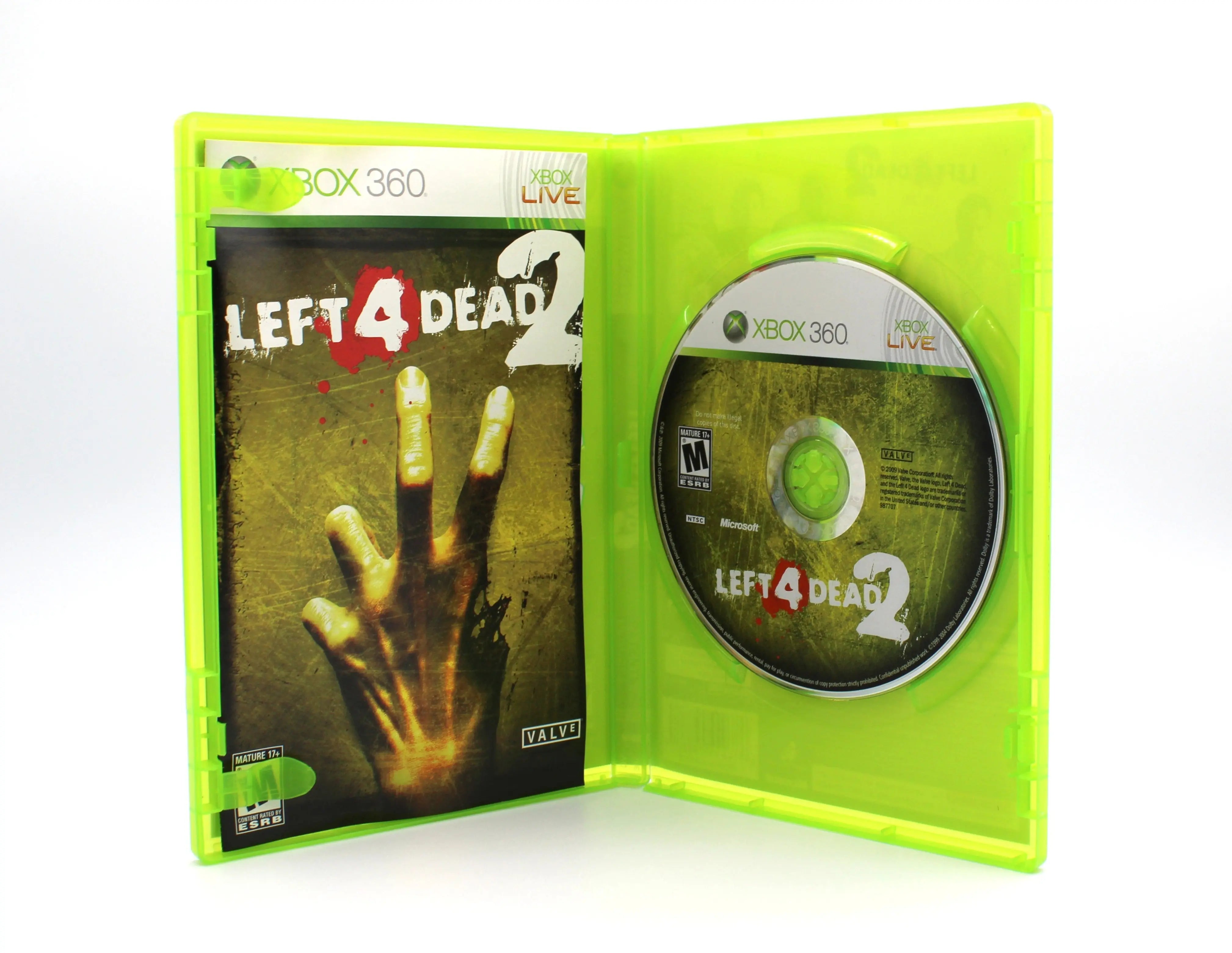 Opened case view of Left 4 Dead 2 for Microsoft Xbox 360 NTSC-U (2009) OEM black label CIB. Manual and game disc displayed clearly with clean interior condition on a white background.