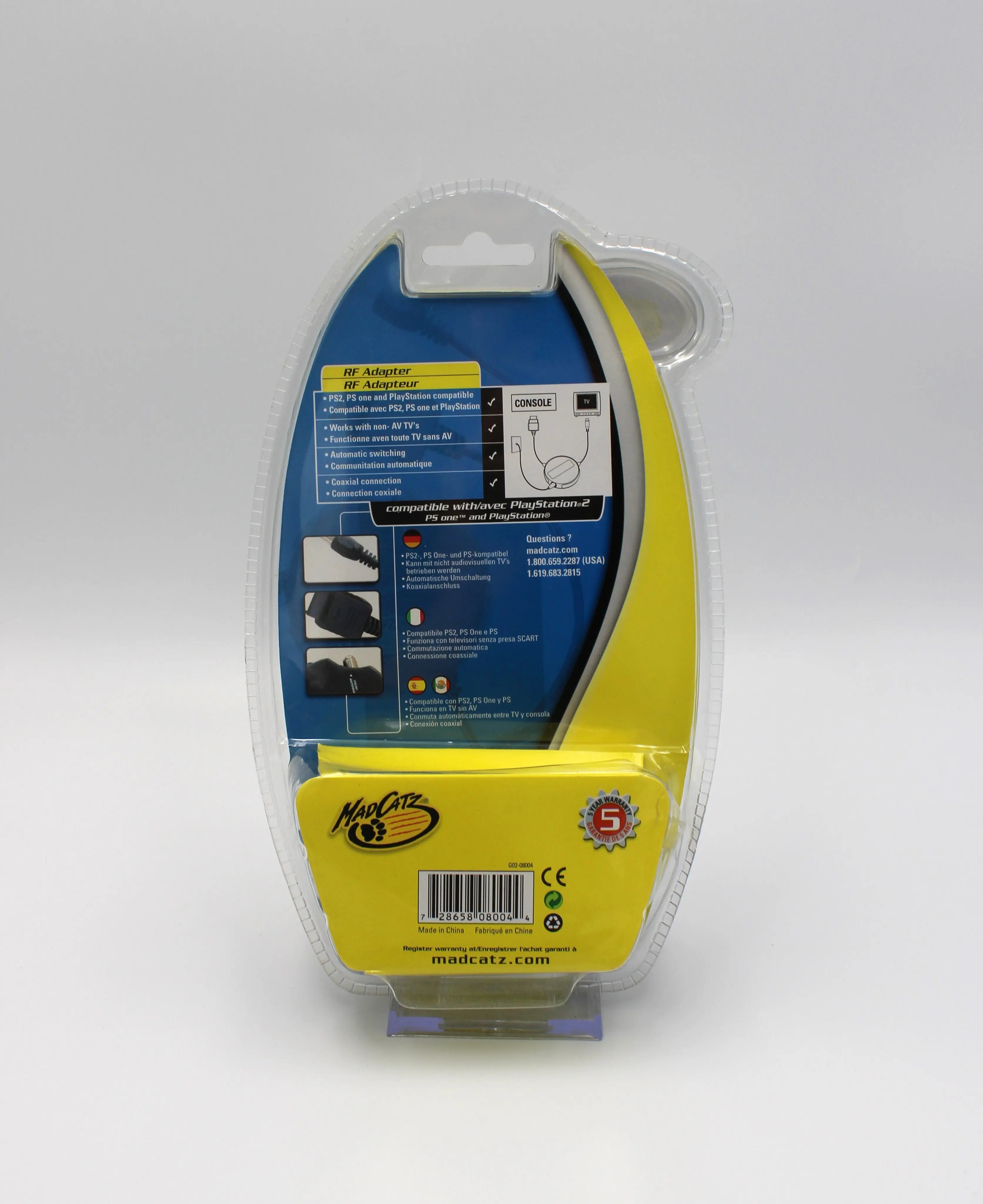 Back view of brand new sealed NTSC-U Mad Catz RF Adapter for the Sony PlayStation 1 and PlayStation 2. PS1/PS2. View back of sealed case with instructions text, Mad Catz logo, and UPC.