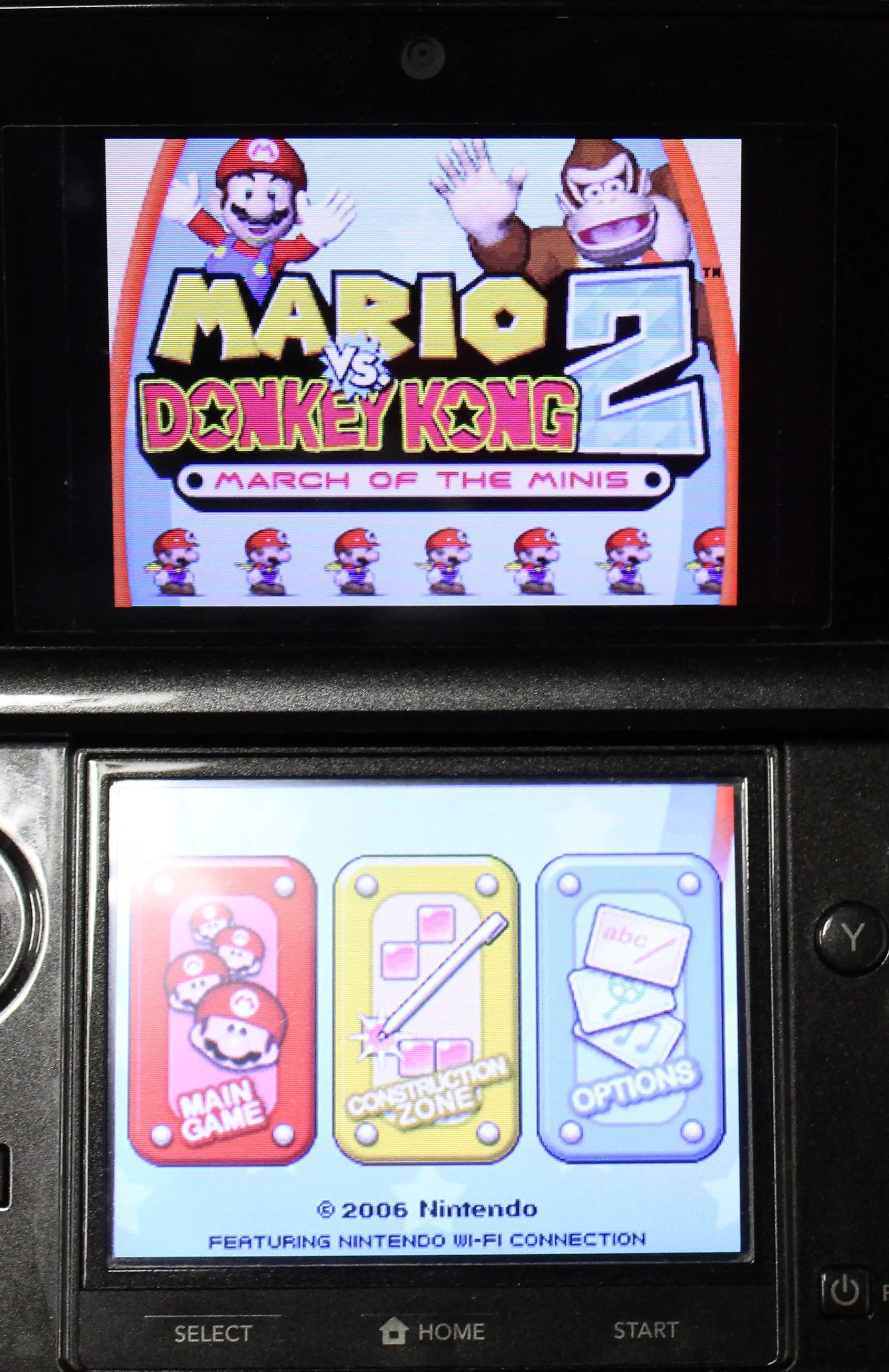 Gameplay image view of NTSC-U Mario vs. Donkey Kong 2: March of the Minis complete in box for Nintendo DS. (2006) CIB with all Inserts. Showing gameplay main menu with options screen. 