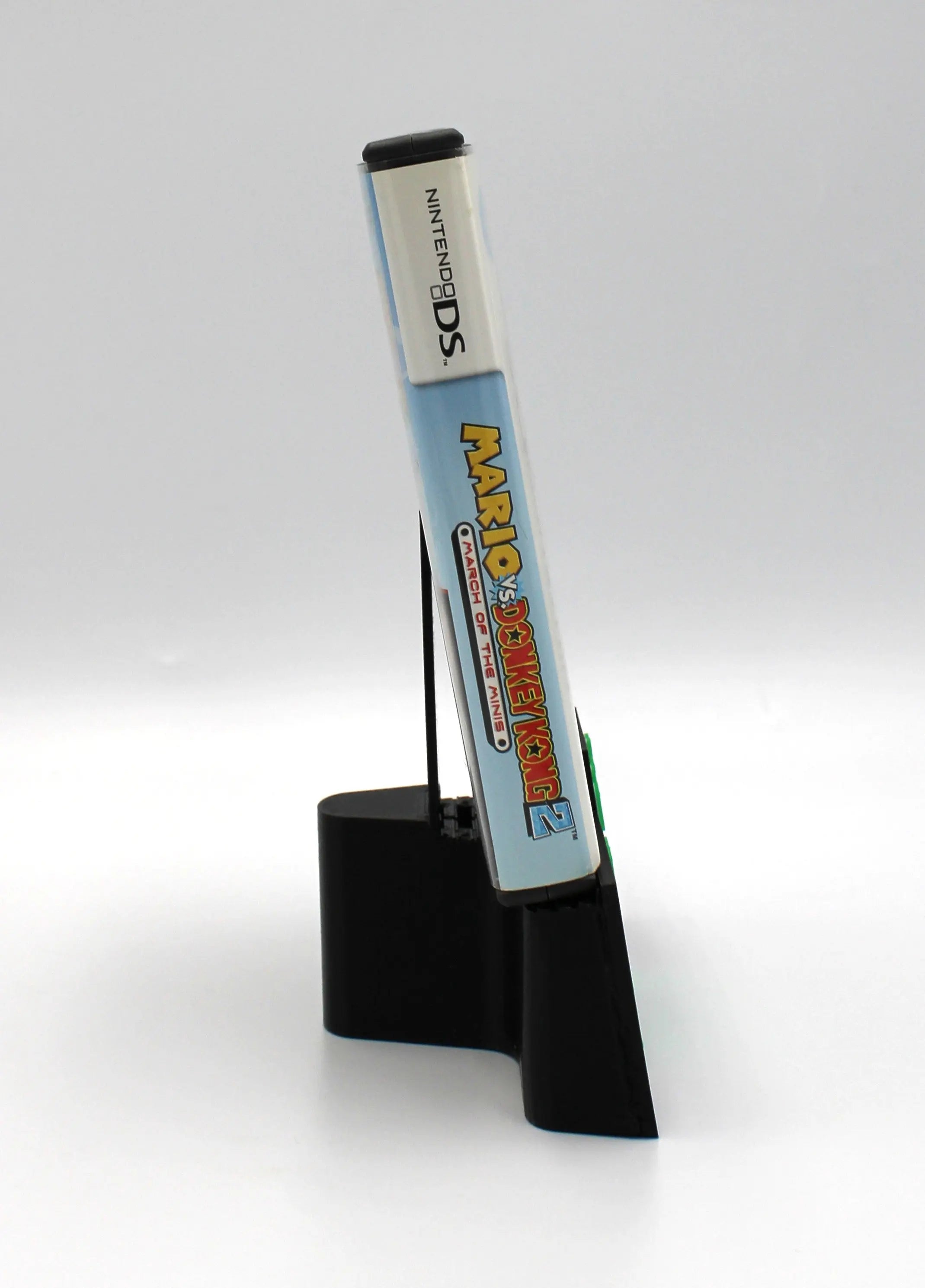 Spine view of NTSC-U Mario versus Donkey Kong 2 March of the Minis complete in box for Nintendo DS. (2006) CIB with all Inserts. Showing spine case cover with title text and condition.