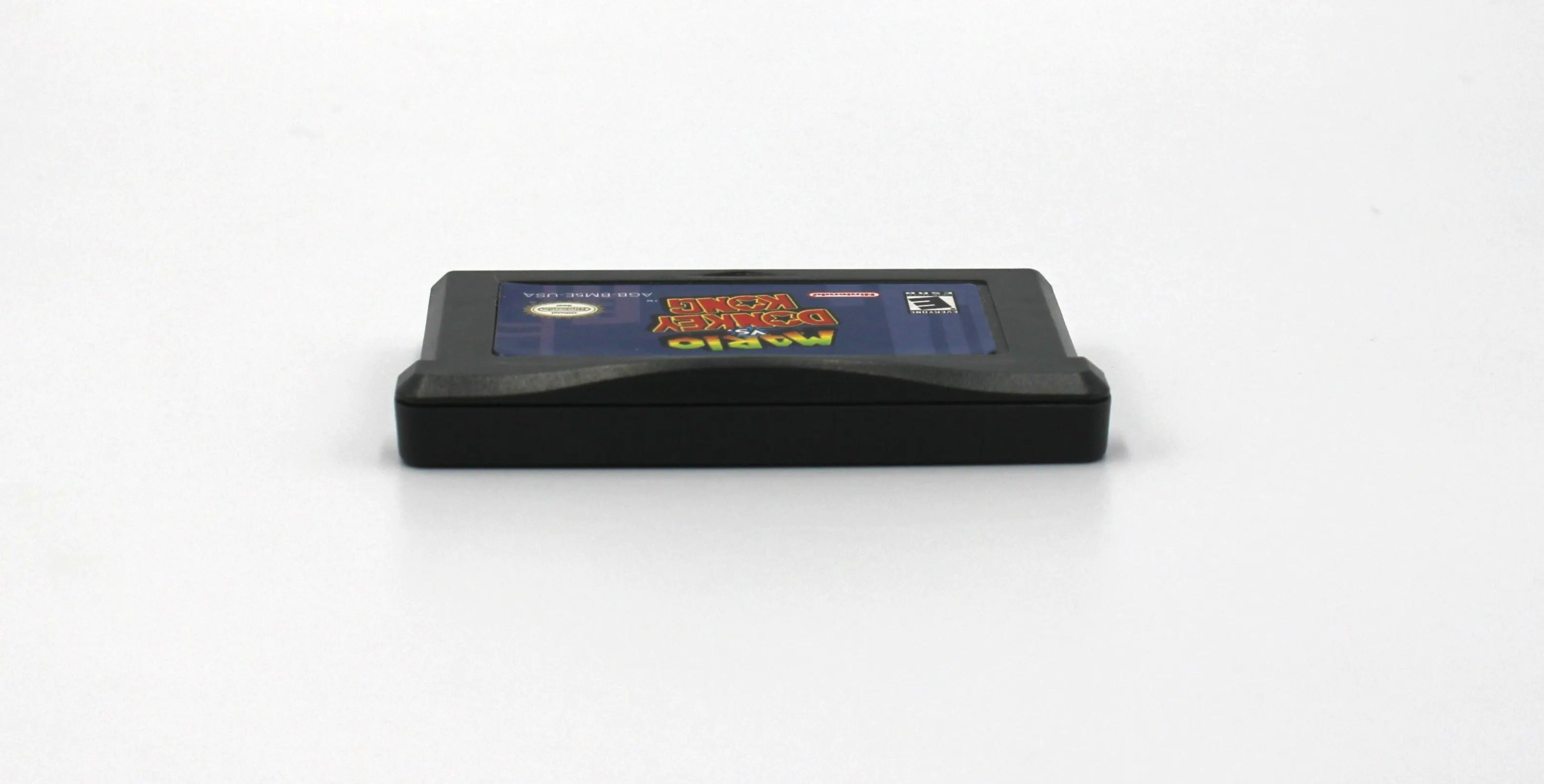 Top edge view of Mario vs. Donkey Kong for Nintendo Game Boy Advance GBA – Authentic Game Cartridge (2004) NTSC-U, showing clean alignment of shell halves and label edge.