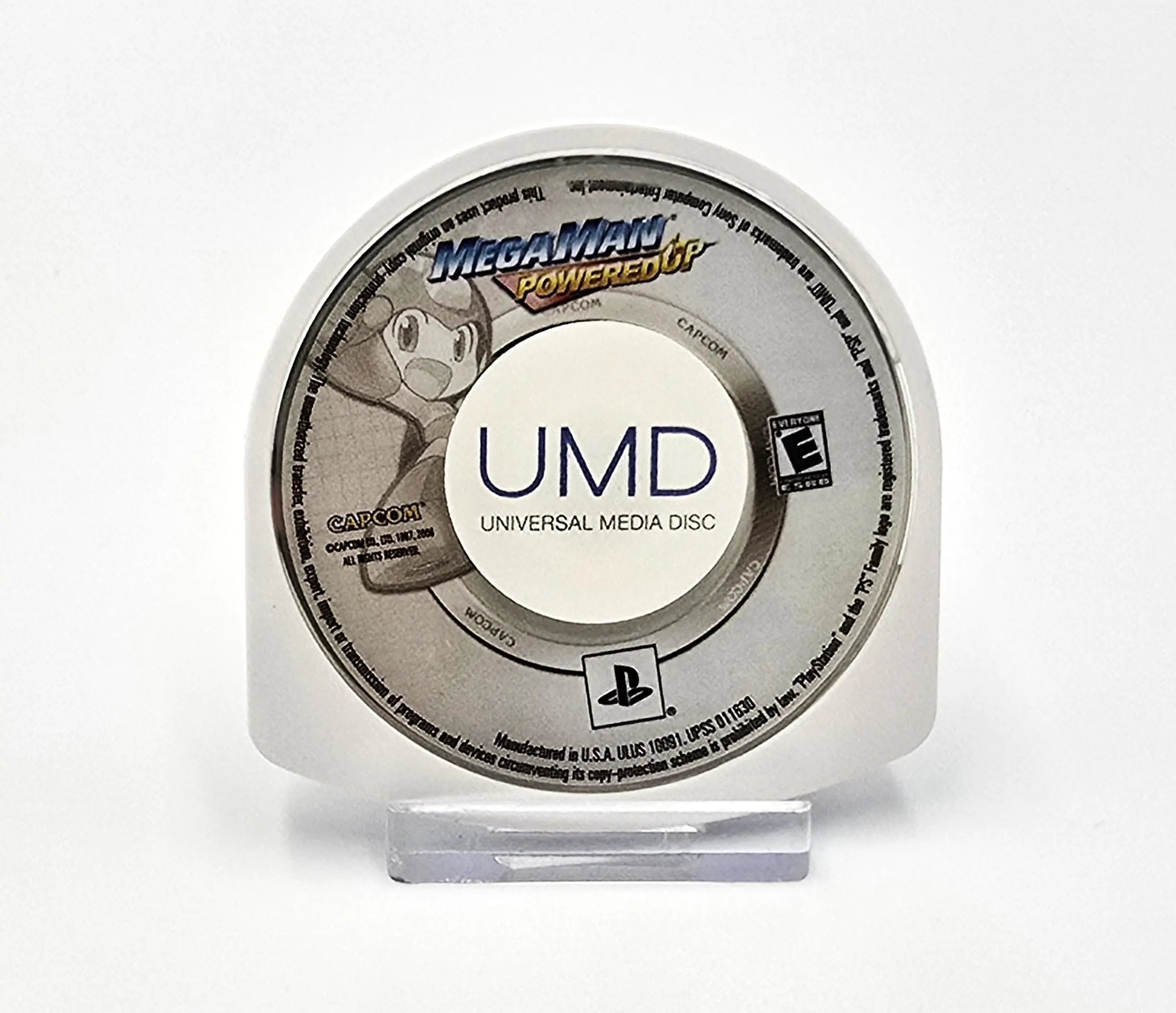 Front label view of authentic UMD disc for Mega Man Powered Up for Sony PlayStation Portable PSP (2006) NTSC-U, featuring Mega Man artwork and Capcom logo