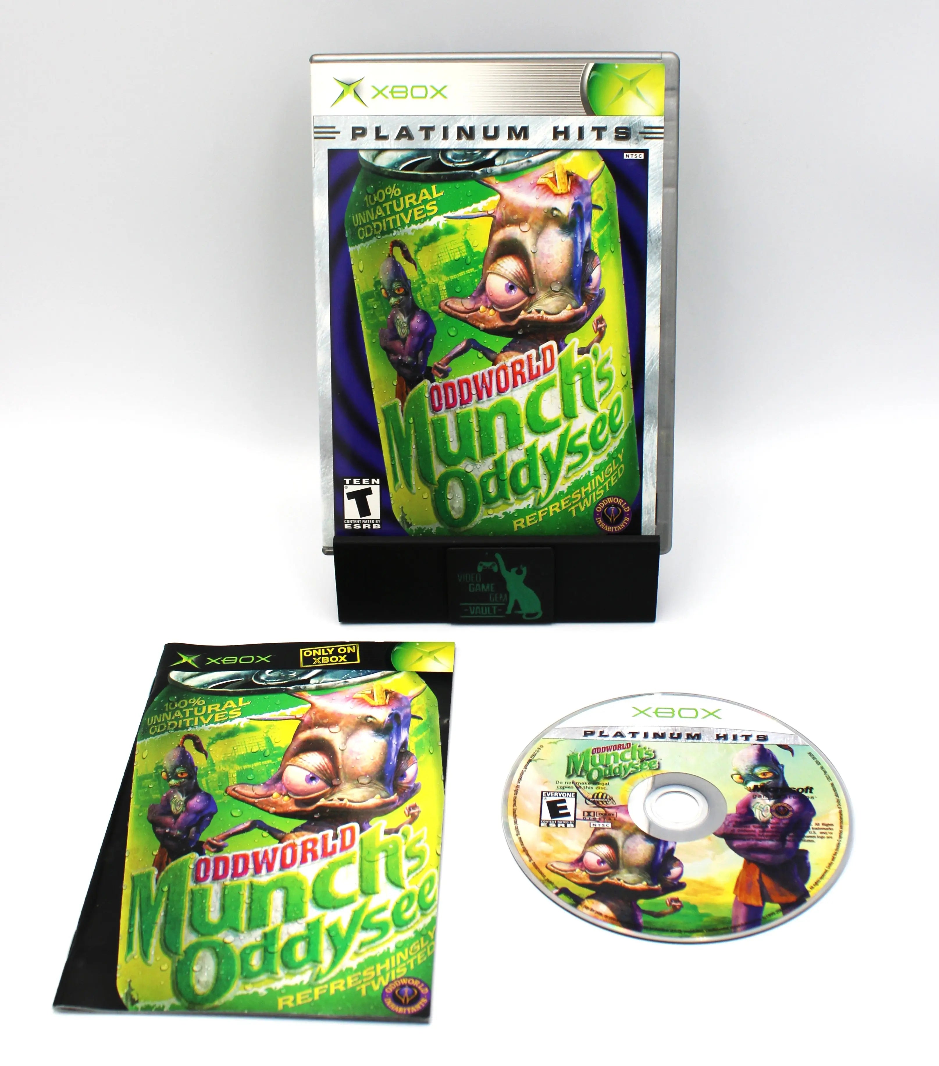 Complete in box display image of Oddworld: Munch’s Oddysee Platinum Hits for Microsoft Xbox Original – CIB with Manual (2001) NTSC‑U, showing the closed case front, manual, and disc laid out together.