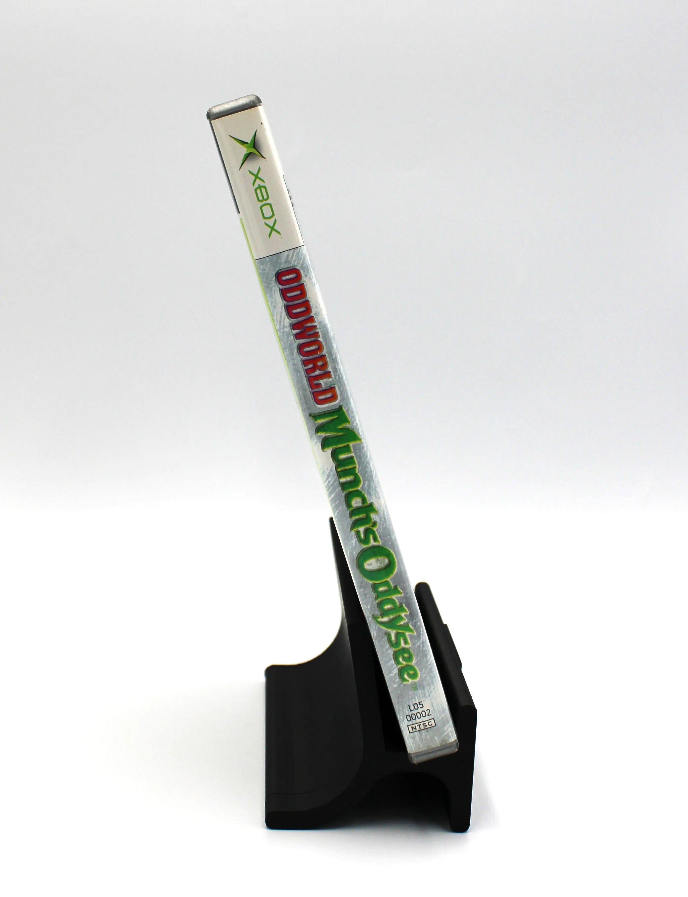 Spine view of the case for Oddworld: Munch’s Oddysee Platinum Hits for Microsoft Xbox Original – CIB with Manual (2001) NTSC‑U, showing the title text alongside the Platinum Hits logo.