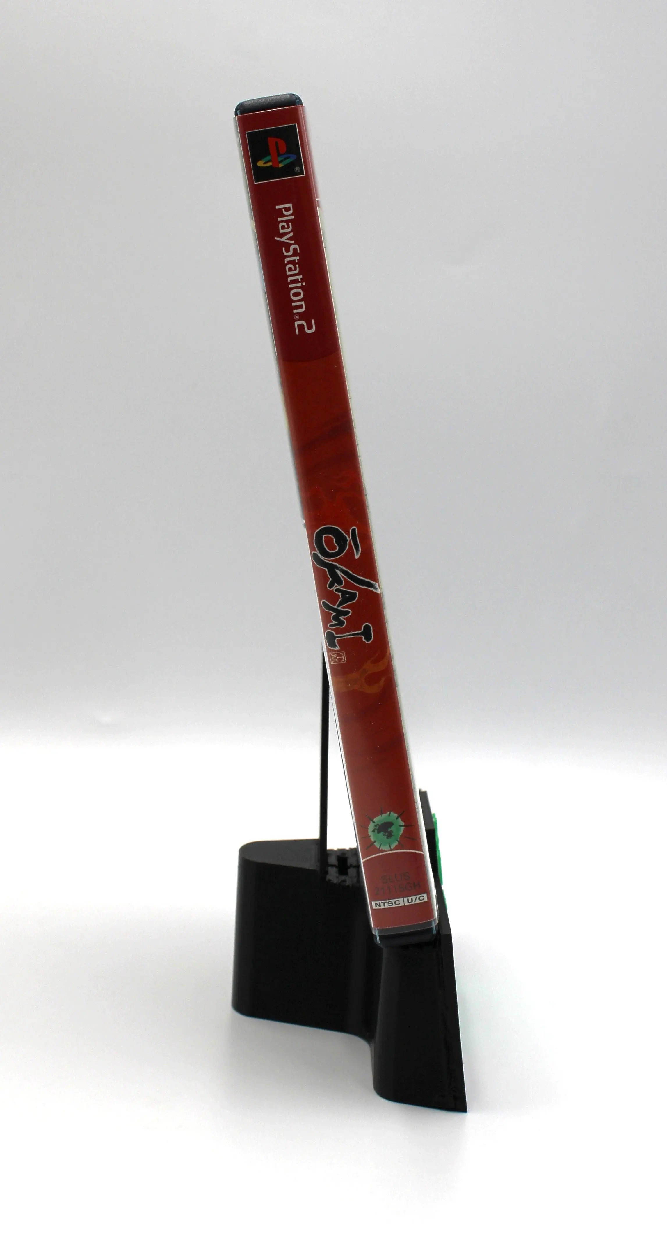 Spine image of Okami for the Sony PlayStation 2. Greatest Hits NTSC-U edition. Clean case and artwork displayed on a white background.