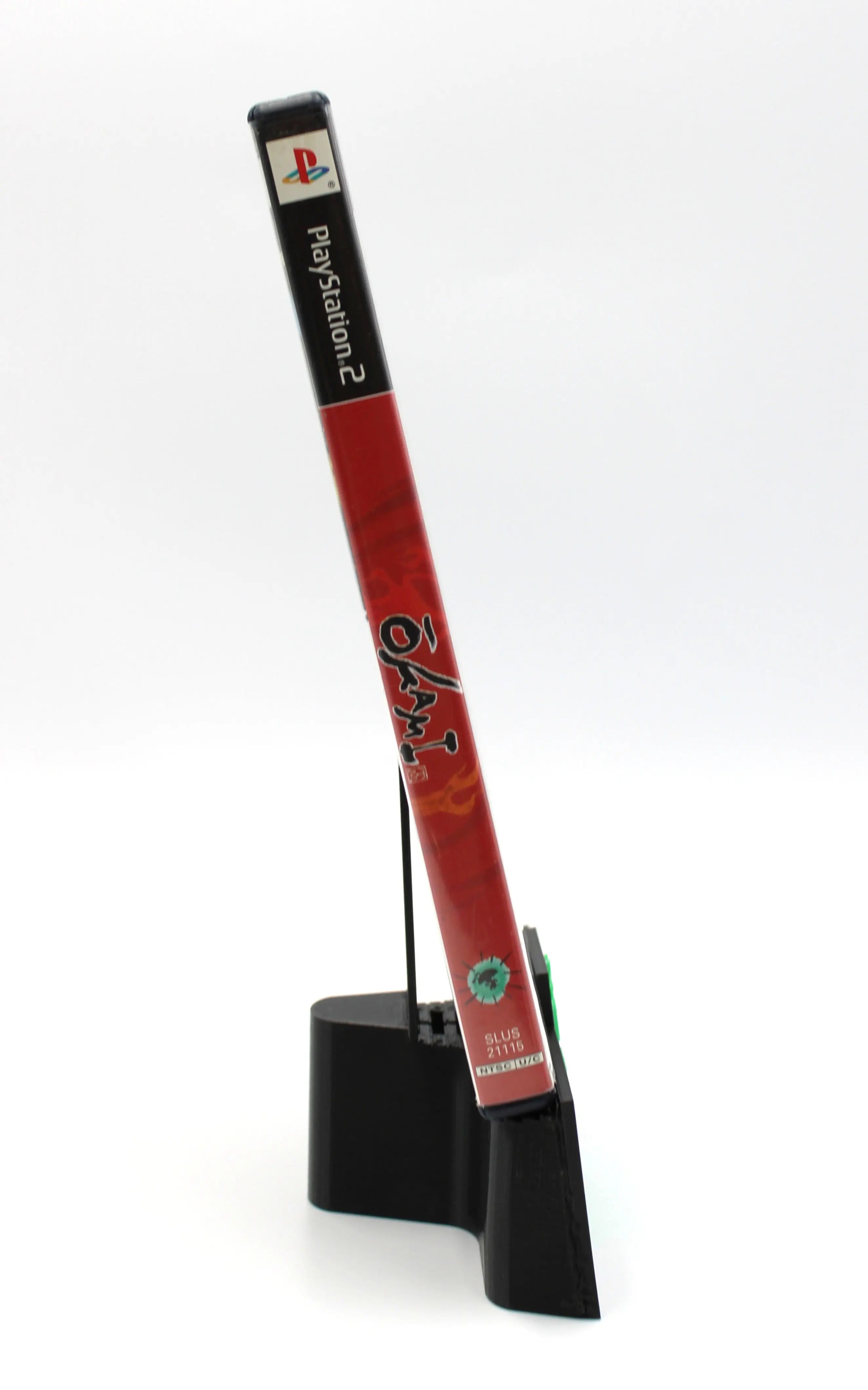 Spine view of Okami PS2 black label edition game case, NTSC-U region, showing title text and PlayStation 2 branding