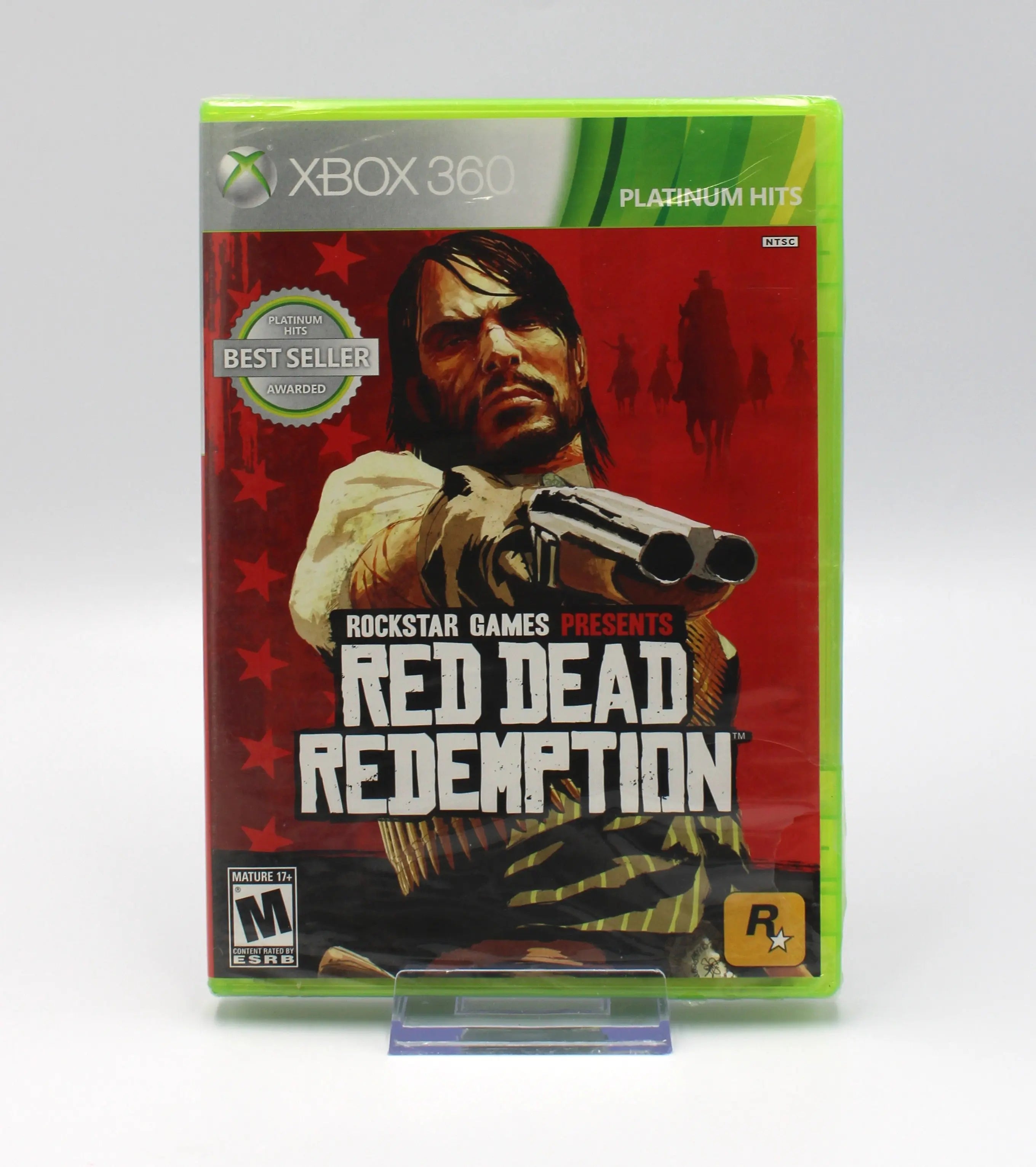 Front view of Red Dead Redemption Platinum Hits for Microsoft Xbox 360 NTSC-U sealed game case, showing main character, esrb rating, platinum hits, rockstar logo, sealed edges and plastic wrap condition.