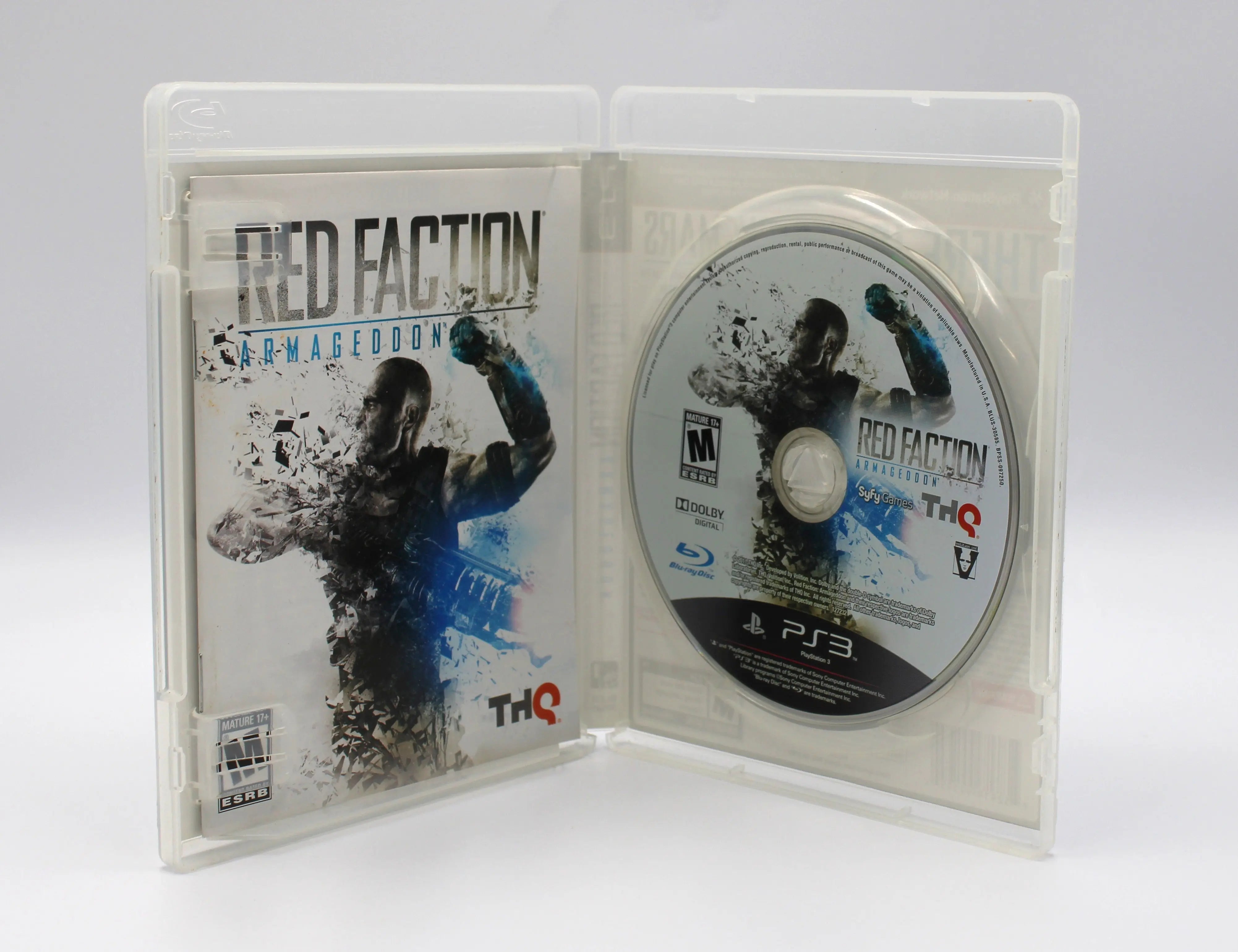 Interior of Red Faction: Armageddon for Sony PlayStation 3 PS3 – CIB with Manual (2011) showing the manual seated in the left panel and the disc secured in the right tray, against a white background.