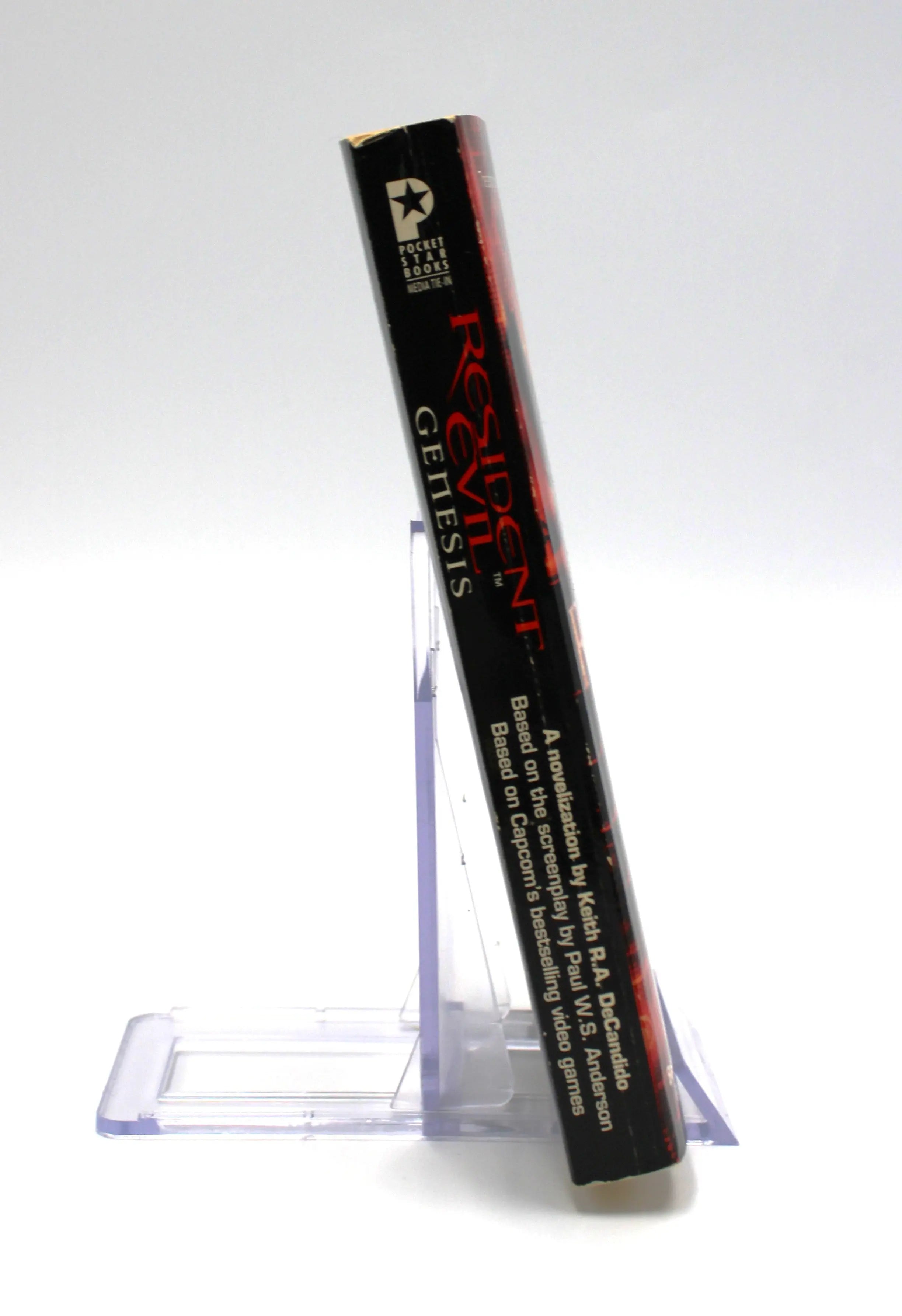 Spine view of Resident Evil: Genesis – First Print Paperback Book (2004), showing Pocket Star Books logo, clean binding, and light corner wear.