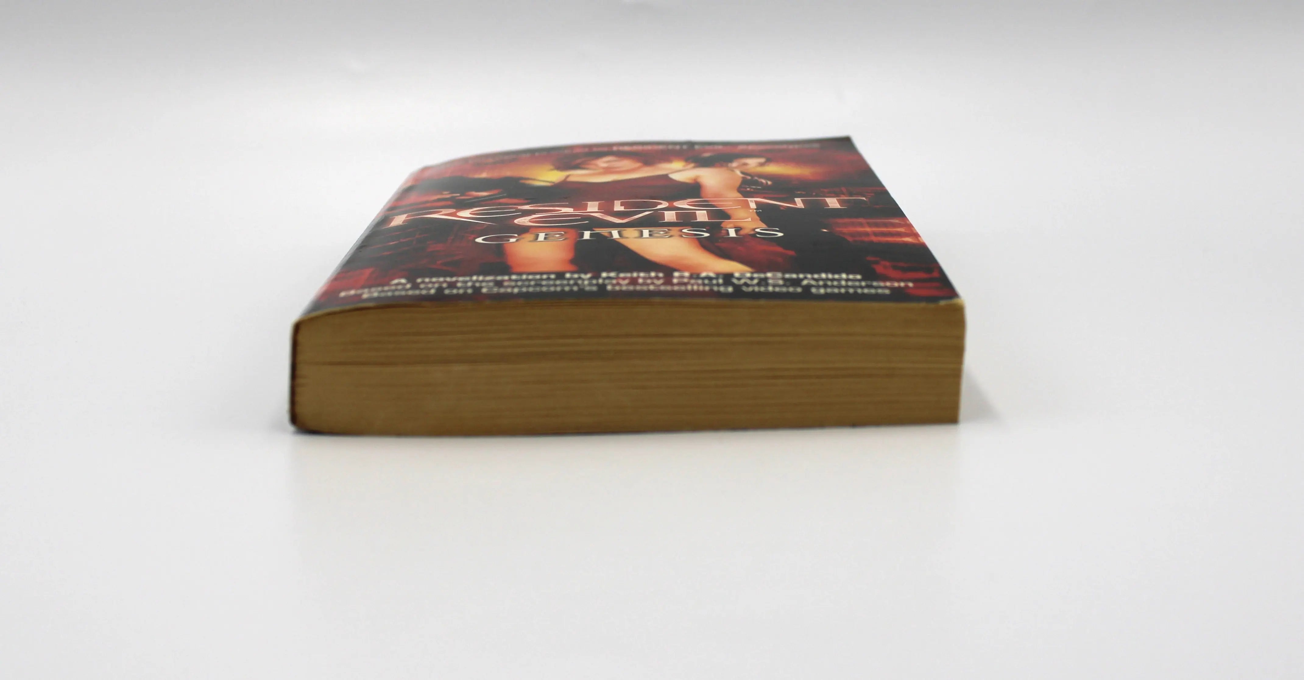 Bottom edge view of Resident Evil: Genesis paperback – shows aged paper toning and smooth binding on first print Pocket Star Books edition.