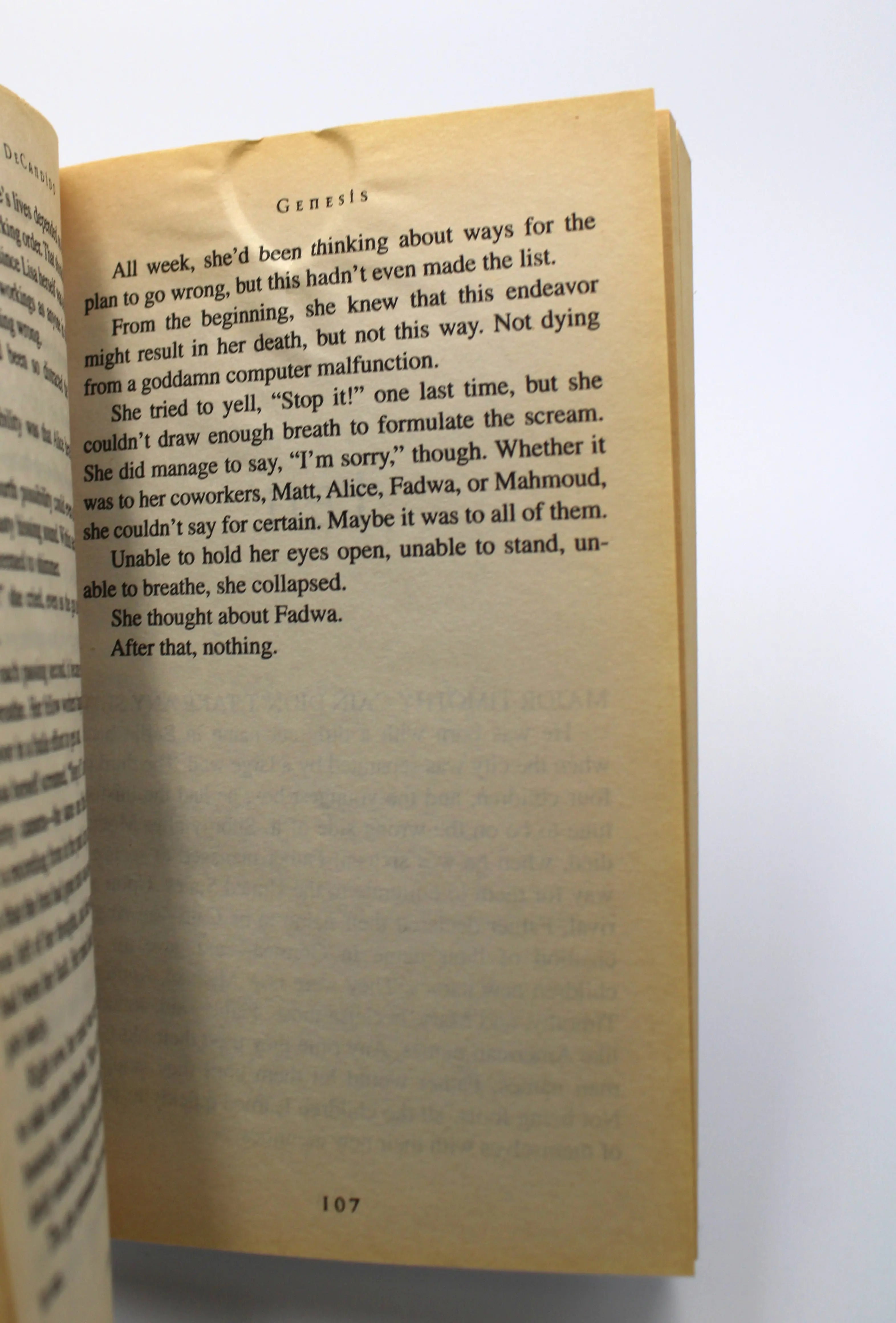 Interior page of Resident Evil: Genesis paperback – page 107 with ripple/dent at the top edge. No writing or tears. Text legible and binding tight.