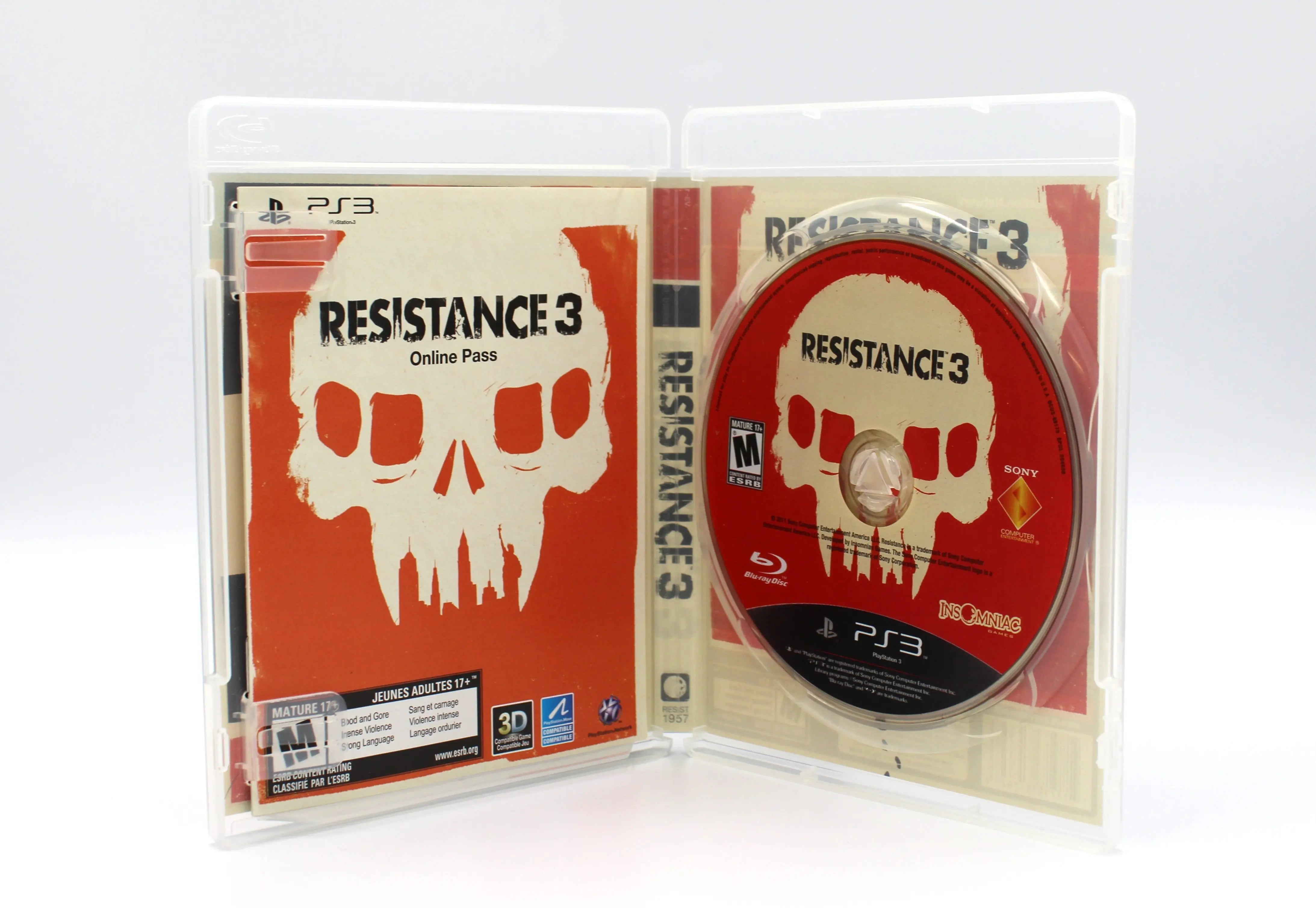 Opened case of Resistance 3 for PS3 NTSC-U, revealing the Blu-ray disc and inserts including manual, online pass insert, and promotional materials.
