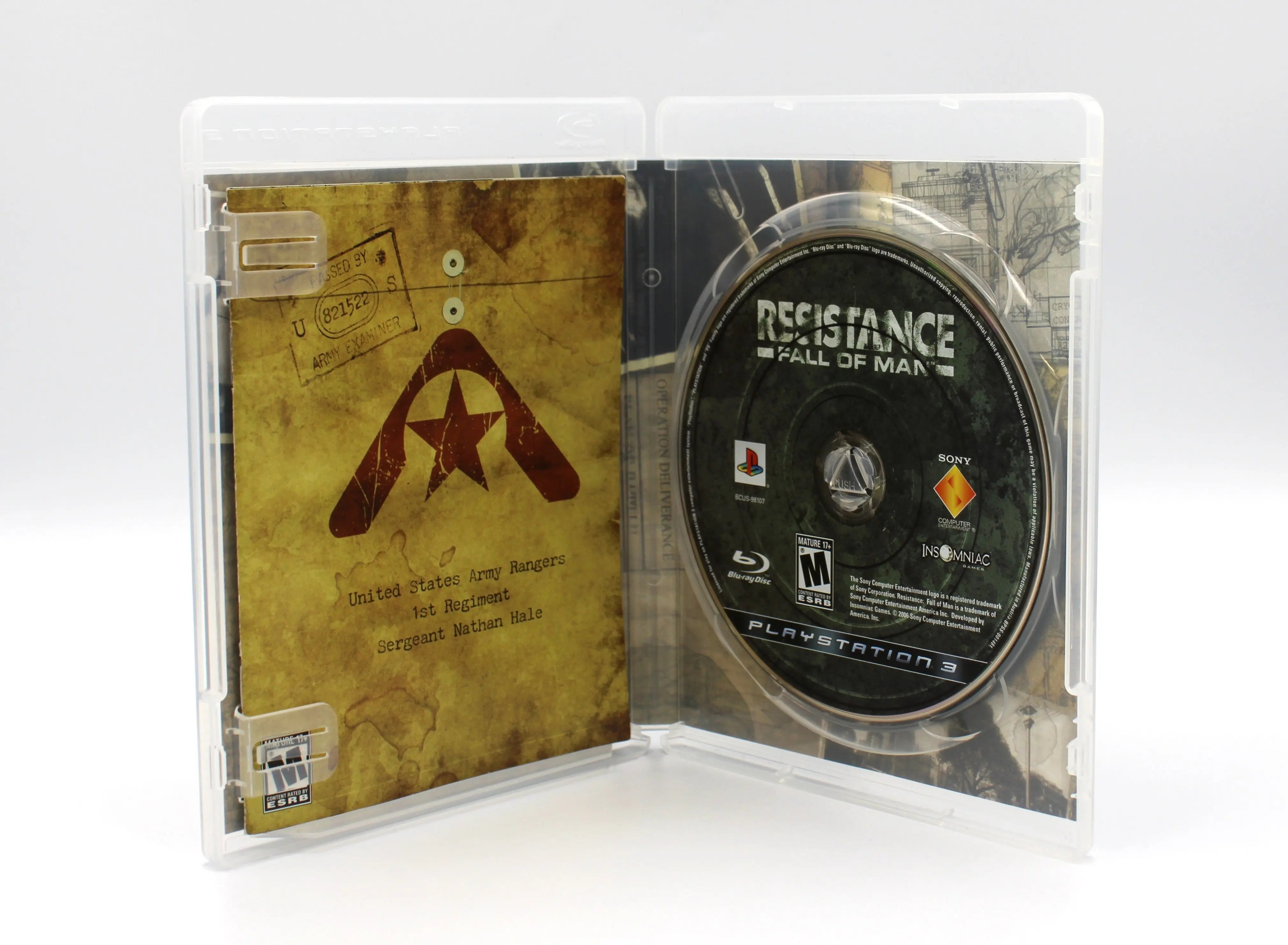 Opened case of Resistance: Fall of Man for PS3 NTSC-U, showing the Blu-ray disc, manual, and additional inserts inside the case.