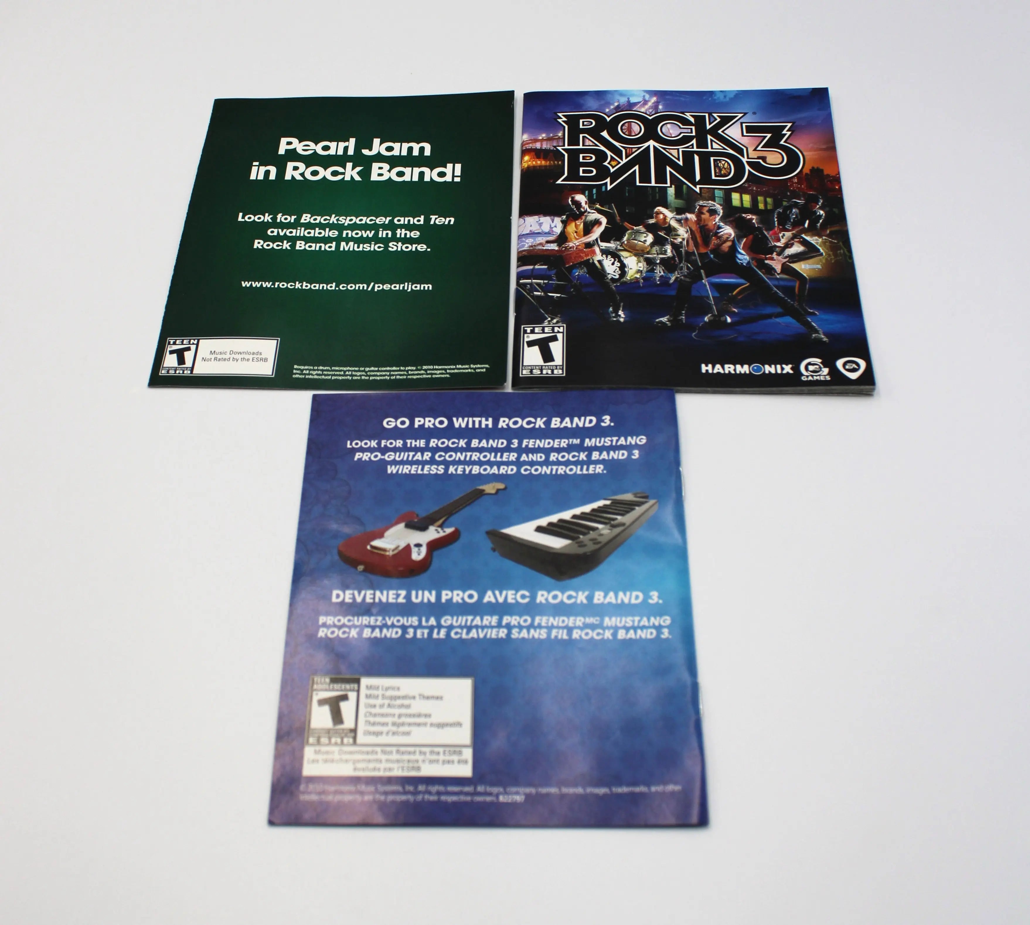 Flat layout of included inserts for Rock Band 3 for Sony PlayStation 3 PS3 – Complete in Box (2010) NTSC-U. Includes Pearl Jam promo flyer, game manual, and Rock Band Pro accessory flyer.