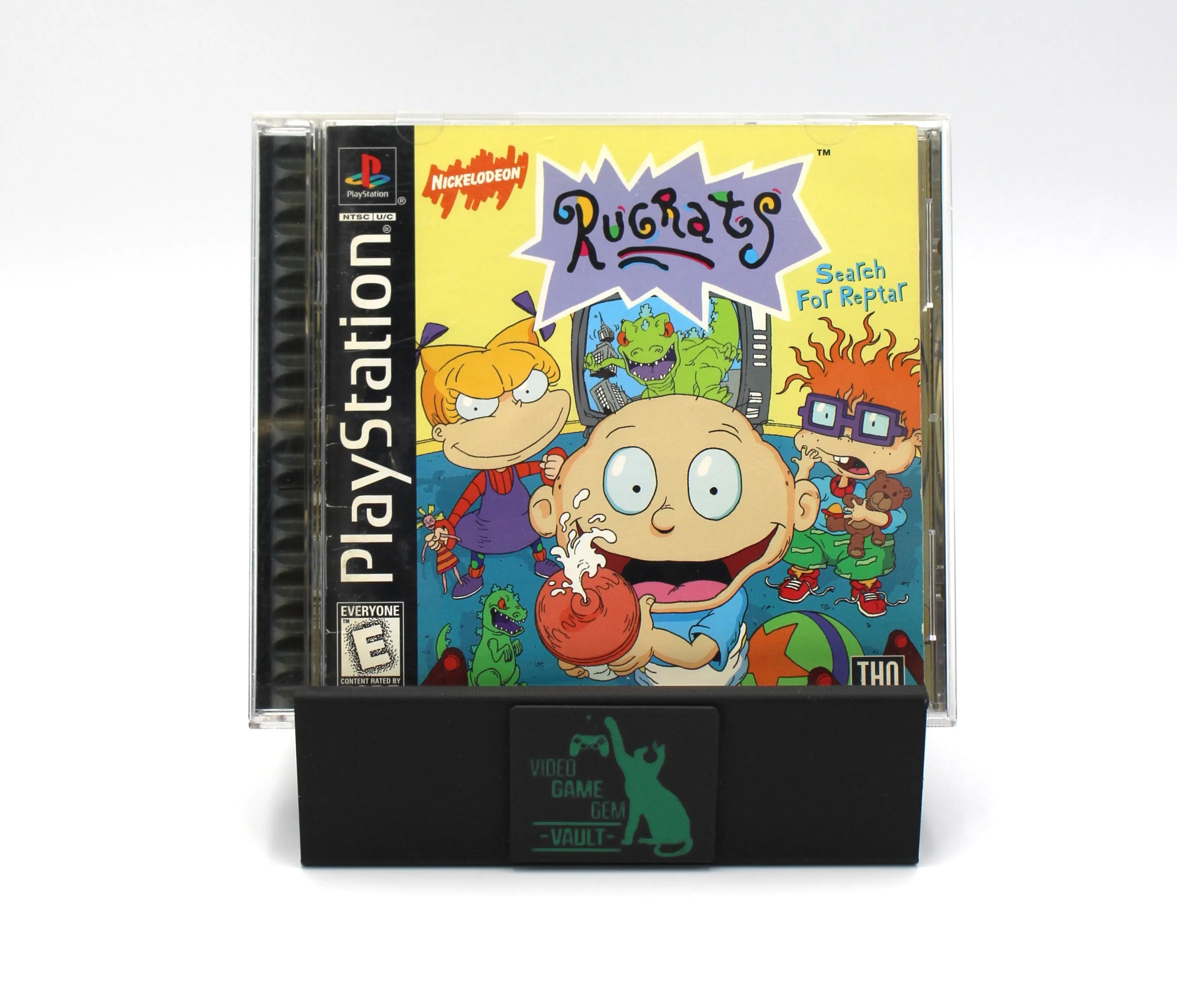 Front cover: Back cover of Rugrats: Search for Reptar for Sony PlayStation 1 (PS1) – CIB with Registration Card (1998) NTSC-U, black label edition, showing game title, PlayStation PS Logo and Symbol, ESRB rating, THQ Publisher. Featuring Tommy, Chucky, and Angelica Characters.