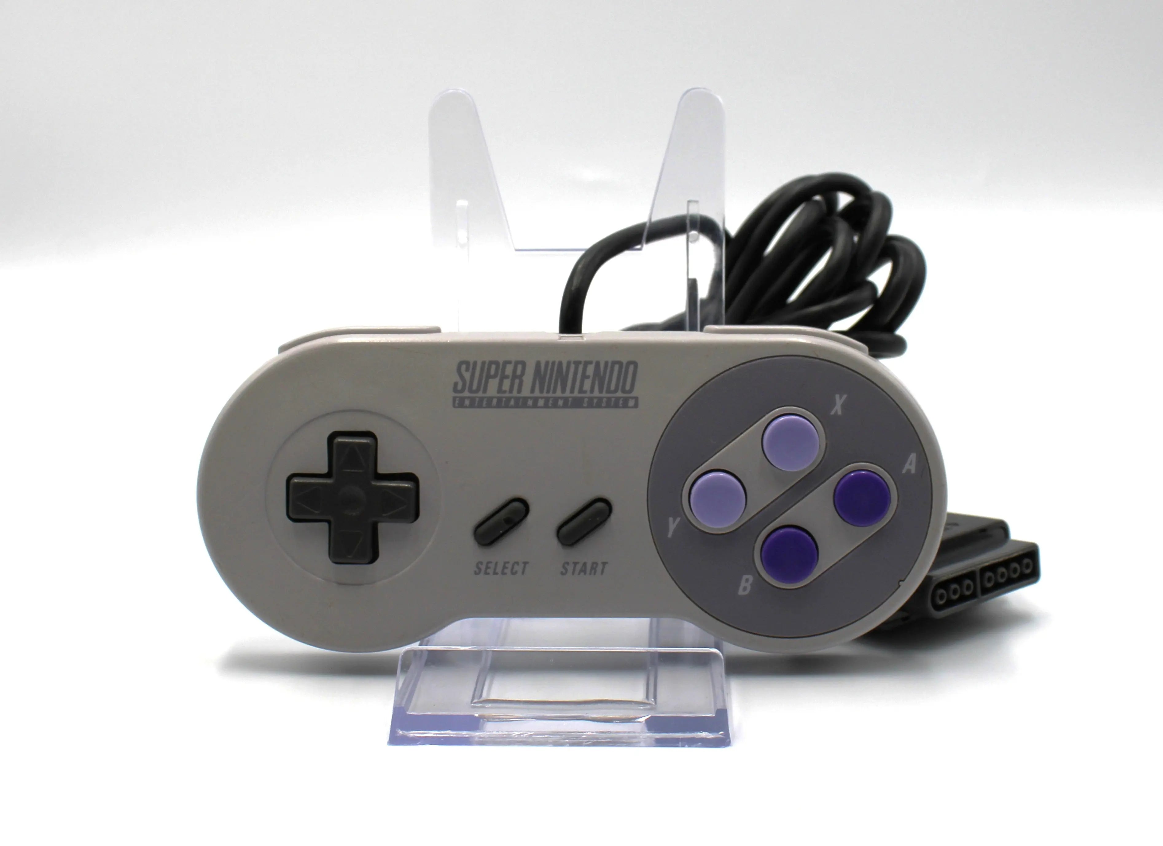 OEM SNES Controller Front View: Refurbished Super Nintendo SNES with OEM controller and cables. 1991 NTSC-U console with a new translucent red shell. Image of front of refurbished SNES controller with text, clean, buttons against a white background.