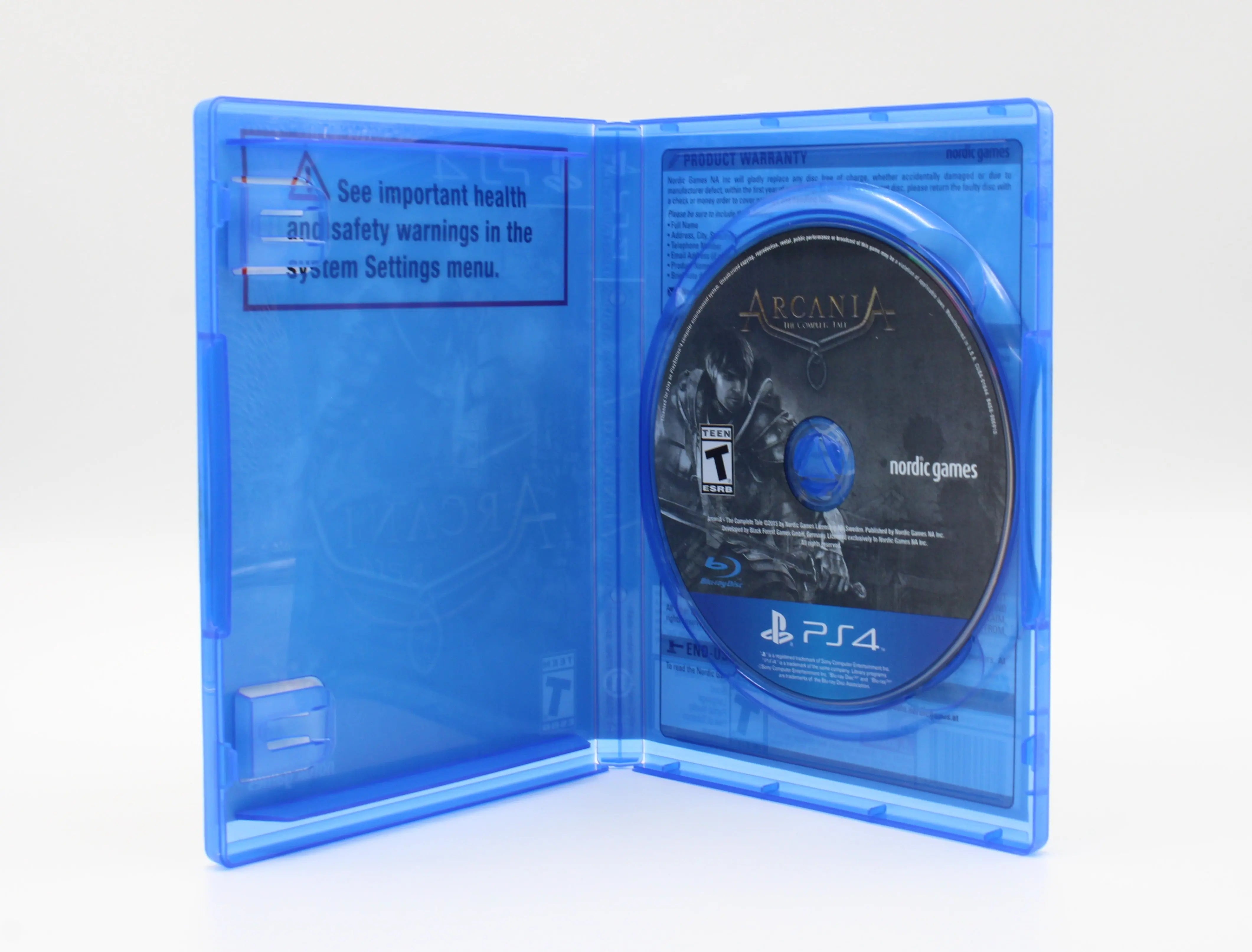 Open case image of Arcania: The Complete Tale for Sony PlayStation 4 PS4 (2015), showing OEM case interior and game disc, NTSC-U edition.