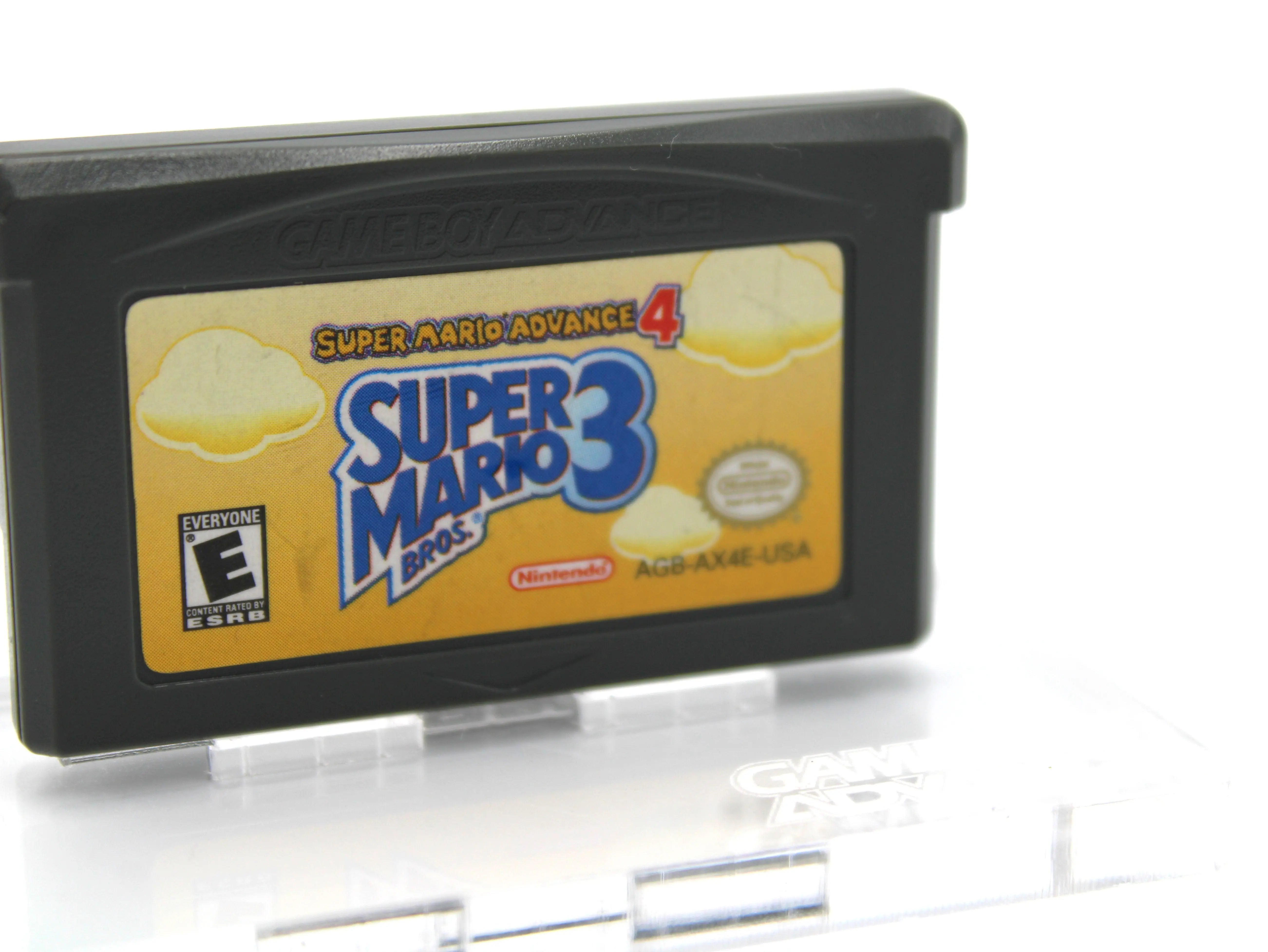 Side front view of Super Mario Advance 4: Super Mario Bros. 3 for Nintendo Game Boy Advance GBA – Authentic Game Cartridge (2003) NTSC‑U, showing minor smudge to Super Mario Bros. 3 blue label and authentic Nintendo label stamp.