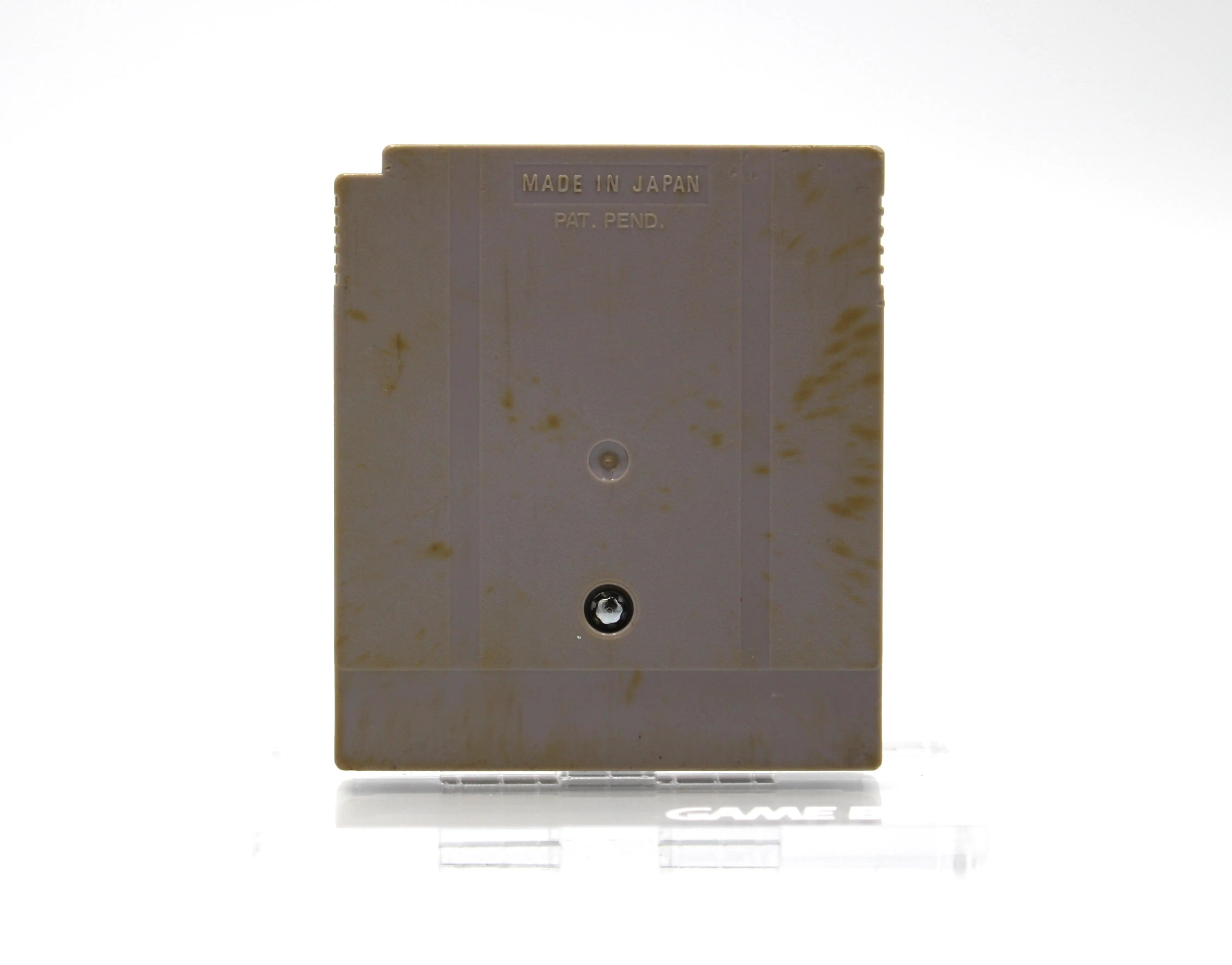 Back shell view of Super Mario Land for Nintendo Game Boy – Authentic Game Cartridge (1989) NTSC‑U, displaying the notch release mechanism, moderation yellowing/discoloration, embossed serial code, and screw positions.