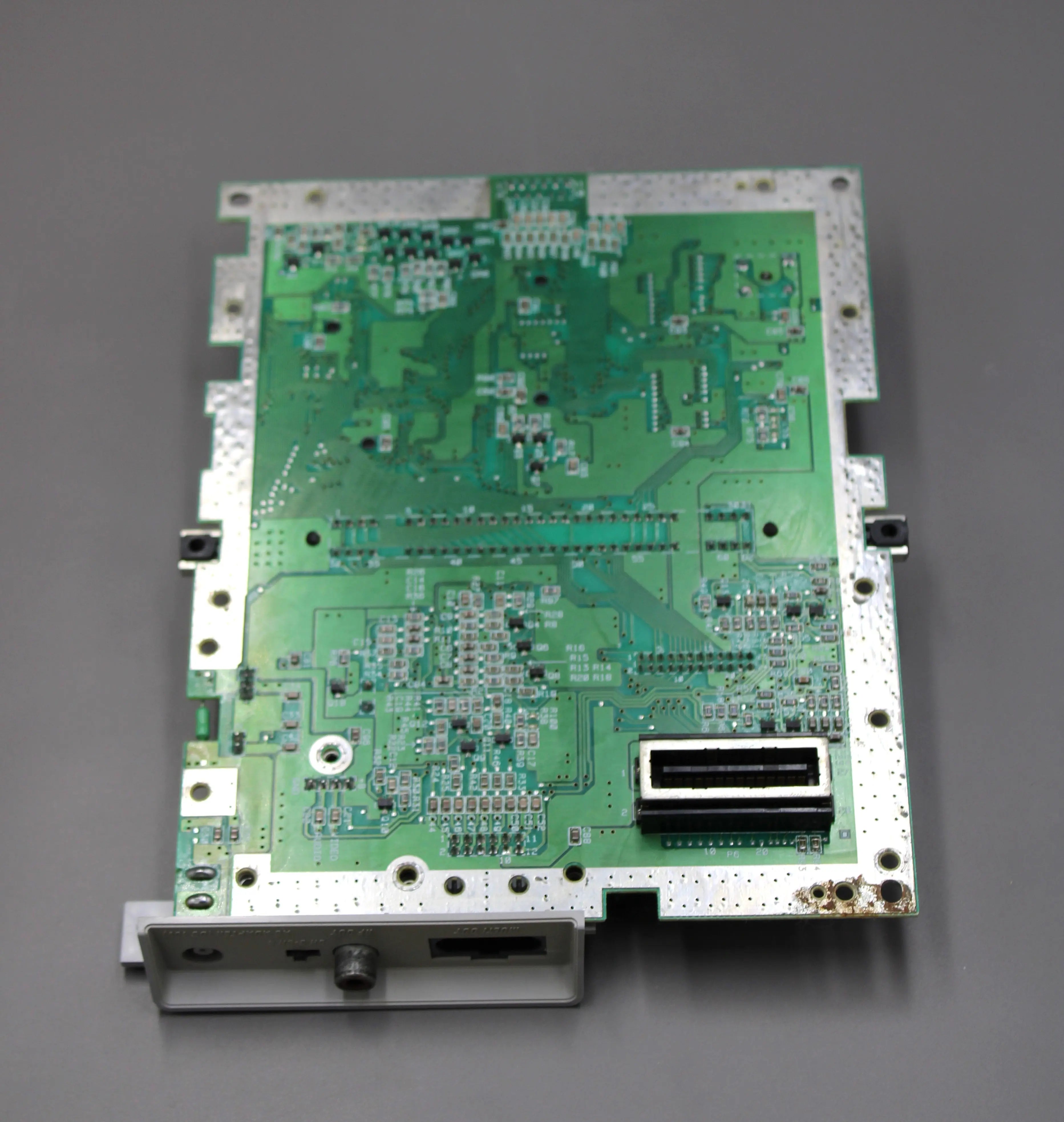 Bottom SNES Board View: Refurbished Super Nintendo SNES 1991 NTSC-U system with a new red shell motherboard. Image of bottom of board showing restoration process and clean chips and parts.