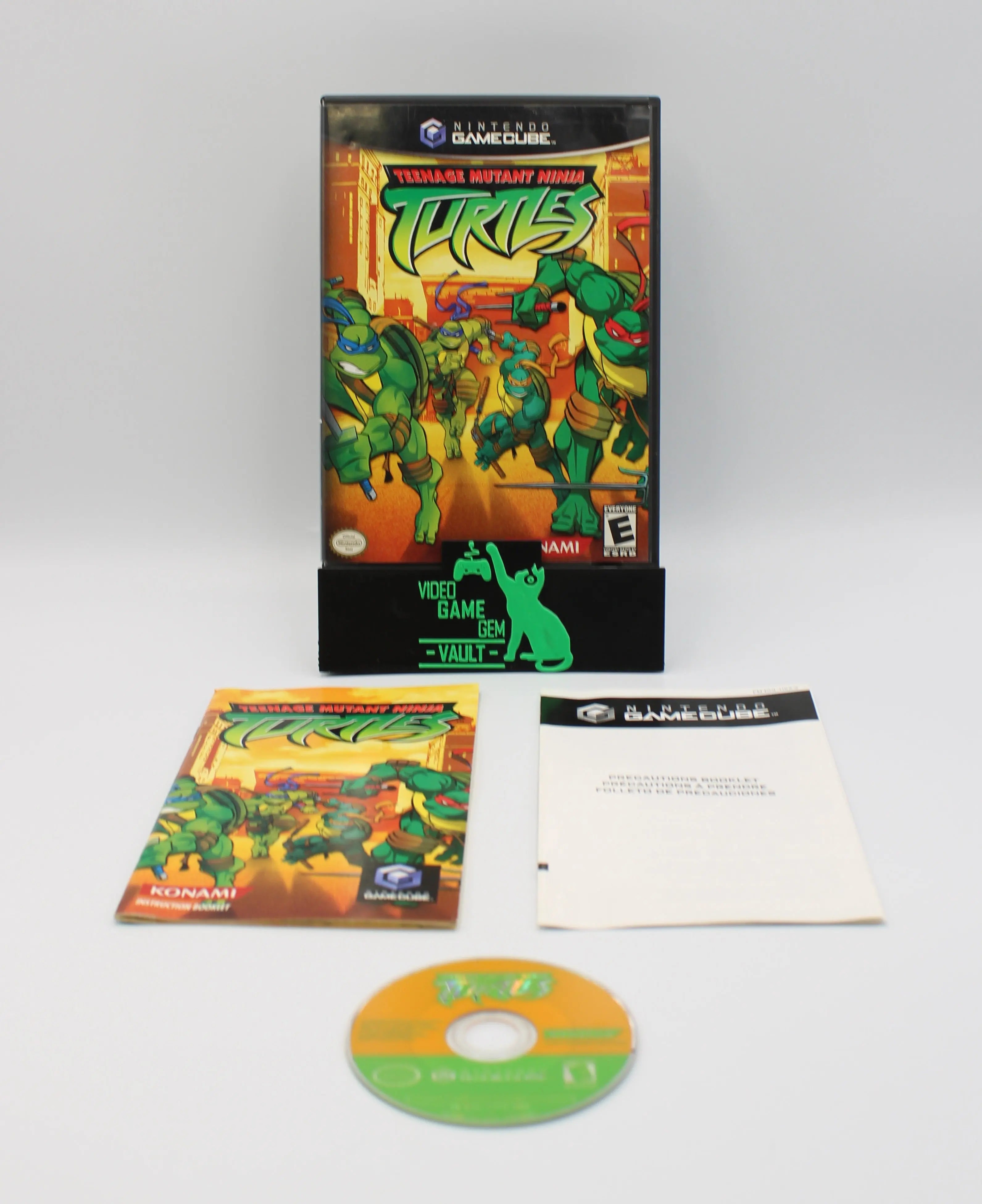 Closed GameCube case front of Teenage Mutant Ninja Turtles for Nintendo GameCube – CIB with manual booklet (2003) shown alongside its original game disc, instruction manual, and any additional inserts on a clean white background to highlight completeness.