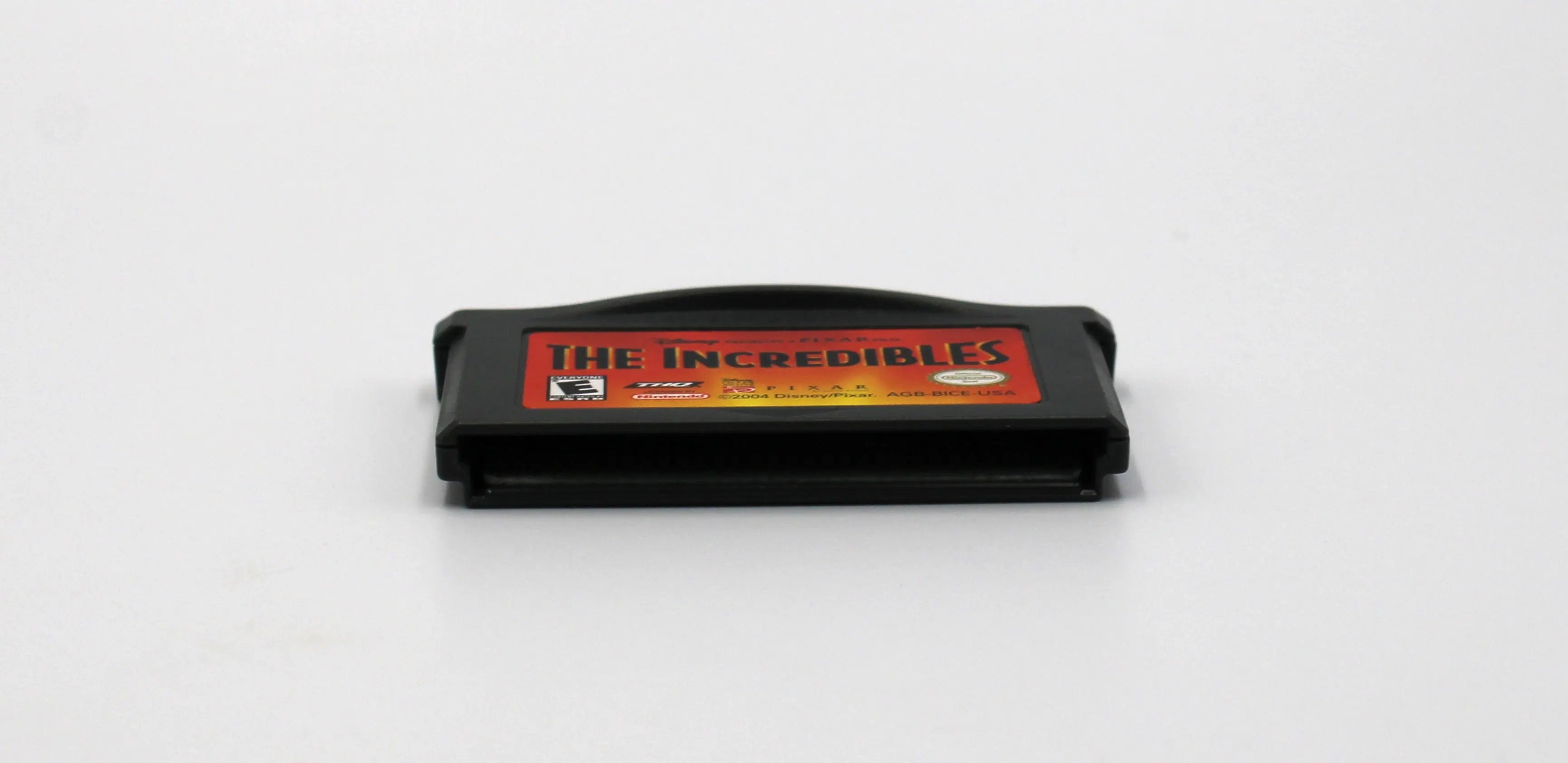 Bottom edge view of The Incredibles for Nintendo Game Boy Advance GBA – Authentic Game Cartridge (2004) NTSC‑U, showing clean, authentic pin connector and internal board fit.
