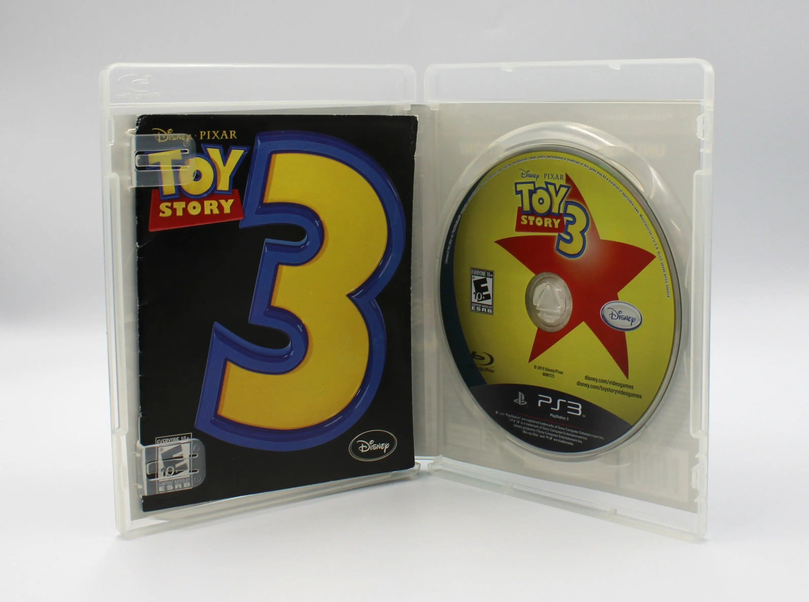 Opened case view of Toy Story 3: The Video Game for Sony PlayStation PS3 – CIB with Manual (2010) NTSC‑U, showing the disc seated in the right tray and the manual tucked into the left side.