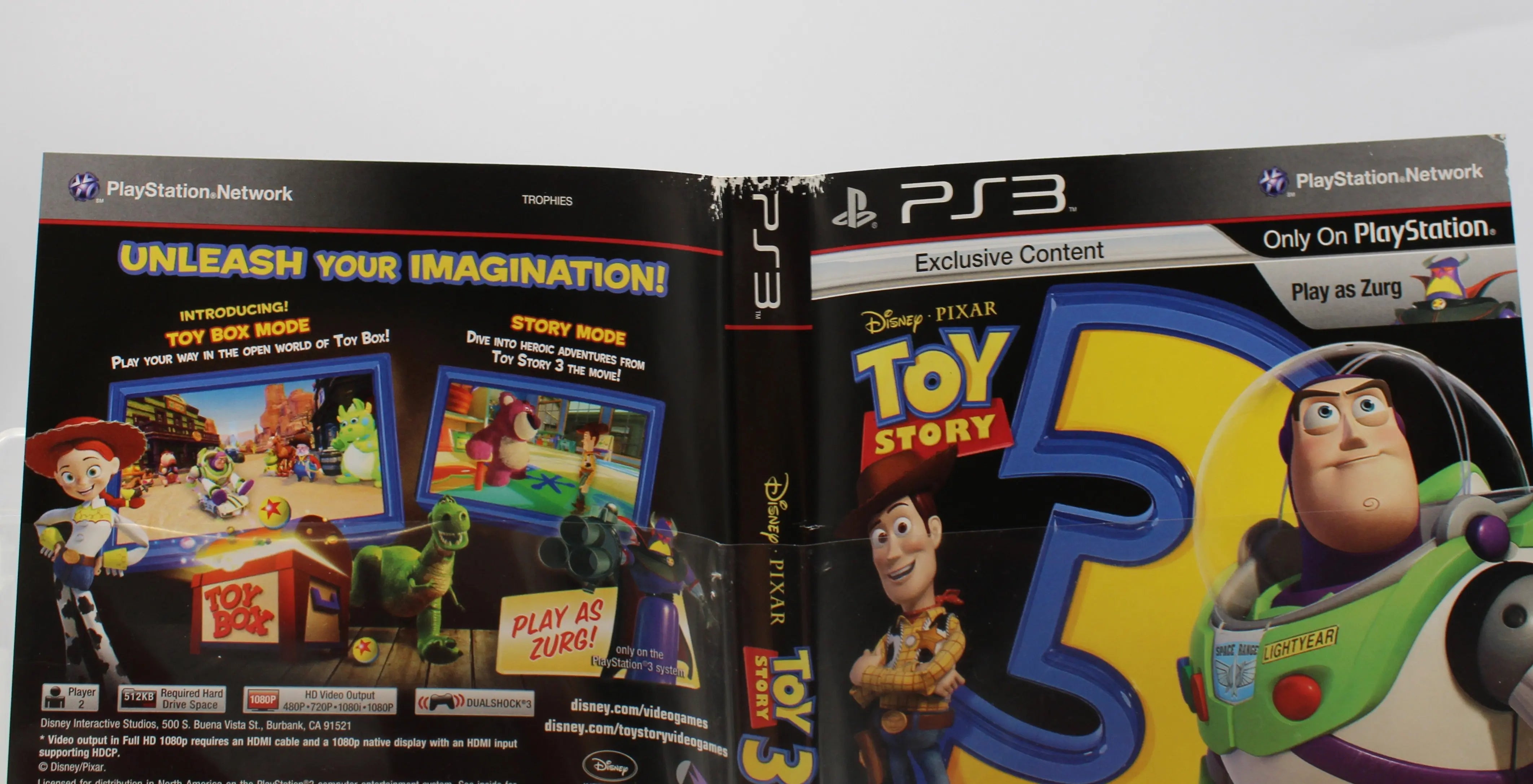 Close‑up of top‑edge wear on the exterior artwork of the Toy Story 3: The Video Game case for Sony PlayStation PS3 NTSC‑U, depicting minor scuffs along the top border mostly to the top of the spine.