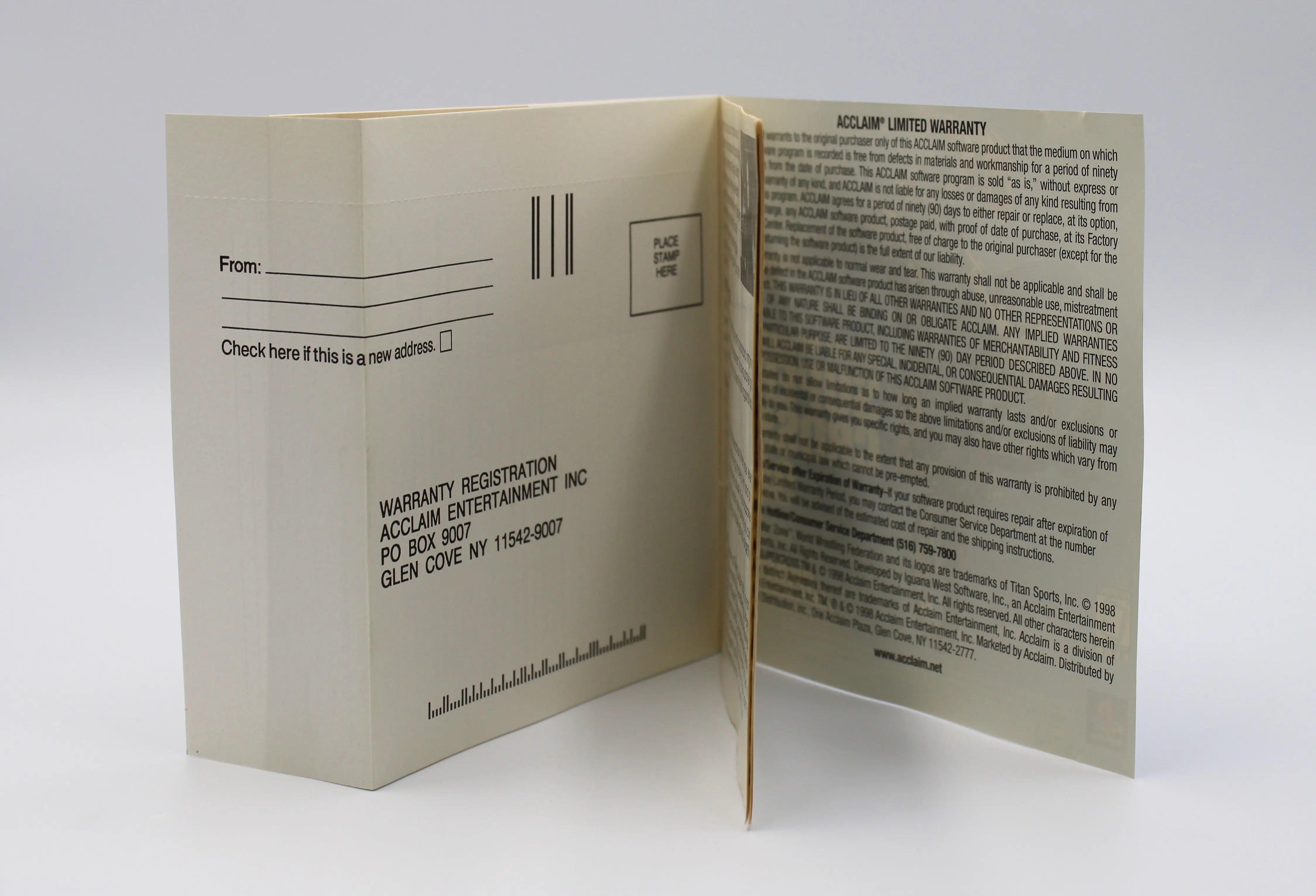 View of front of registration card attached to the front artwork booklet of black label game title WWF War Zone for the Sony PS1. Clearly shows the Acclaim warranty registration card. is unused and intact.