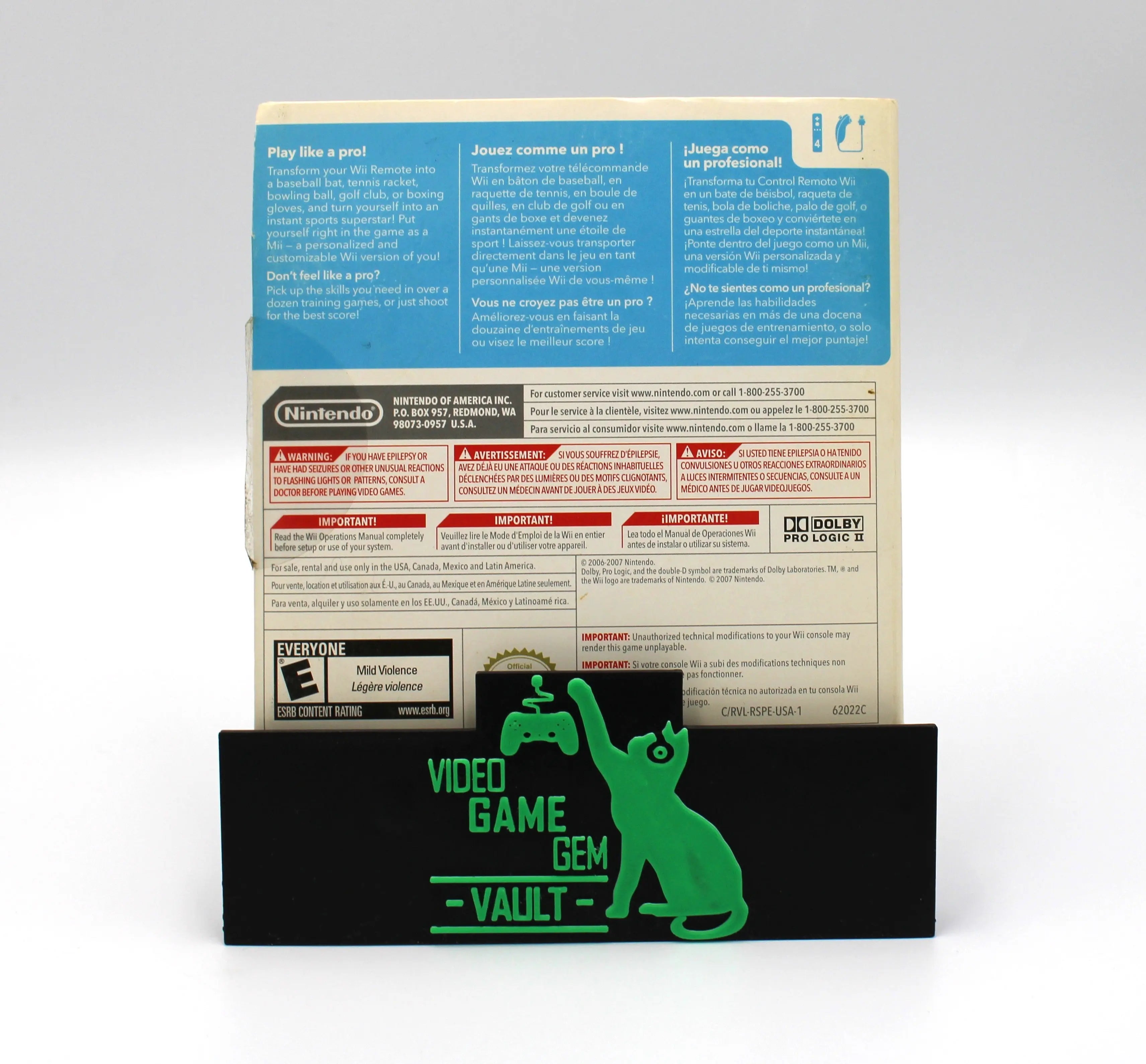 Back case view of a 2006 authentic NTSC-U copy of Wii Sports for Nintendo Wii in cardboard sleeve displayed against a clean white background. E for Everyone rating, seal of quality, game summary text are highlighted. 