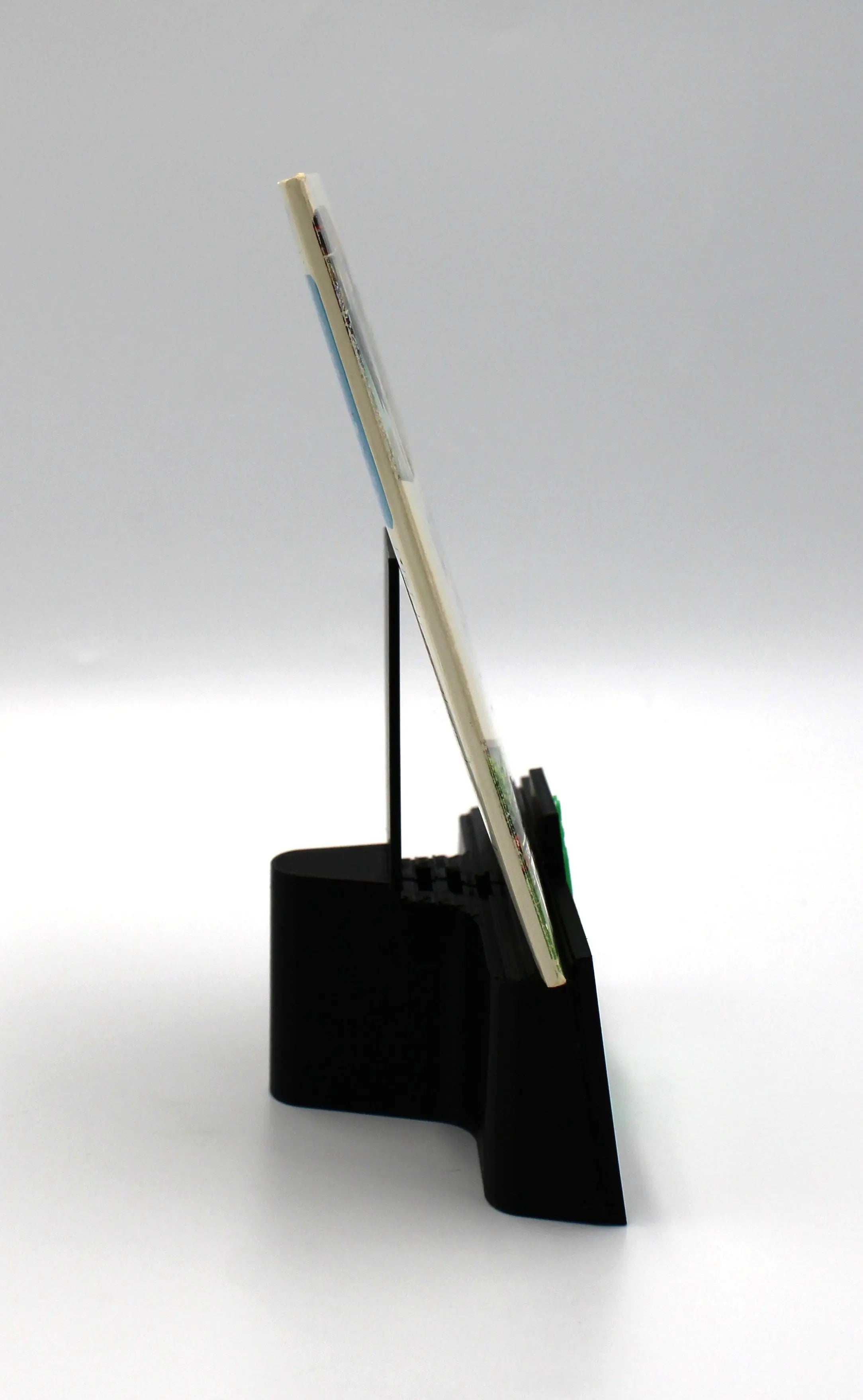 Spine view of a 2006 authentic NTSC-U copy of Wii Sports for Nintendo Wii n cardboard sleeve displayed against a clean white background showing intact case.