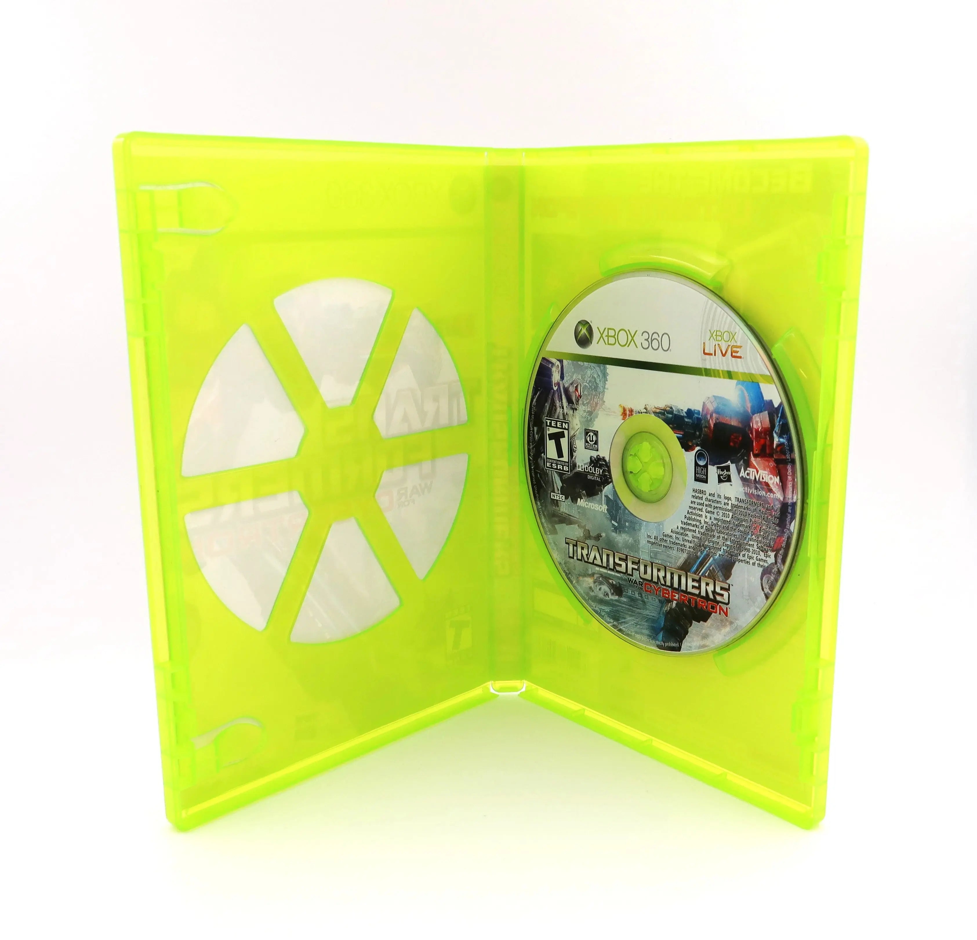 Opened case view of Transformers: War for Cybertron for Microsoft Xbox 360 (2010) NTSC-U, showing original game disc secured inside the OEM green Xbox 360 case. No manual is included.