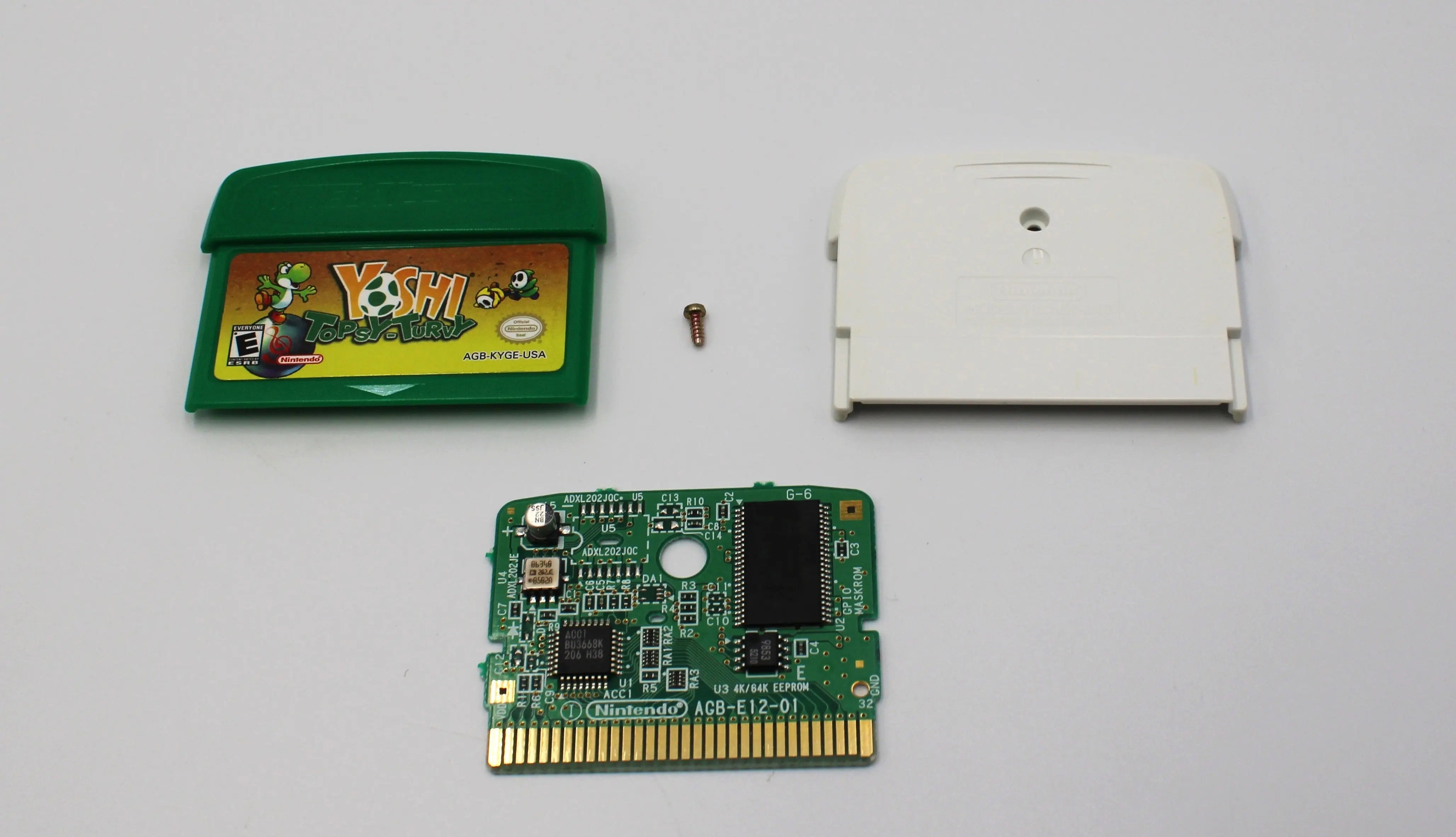 Main display of Yoshi Topsy‑Turvy for Nintendo Game Boy Advance GBA – Authentic Game Cartridge (2005) NTSC‑U. Includes front and back shell, board, and security screw, shown fully disassembled for authenticity verification.
