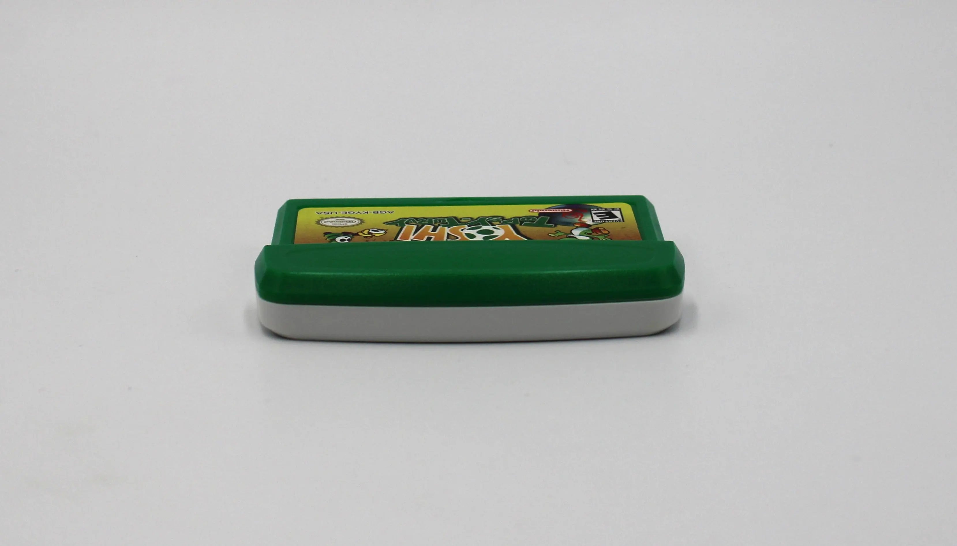 Top edge view of Yoshi Topsy‑Turvy for Nintendo Game Boy Advance GBA – Authentic Game Cartridge (2005) NTSC‑U, showing clean alignment of shell halves and label edge.