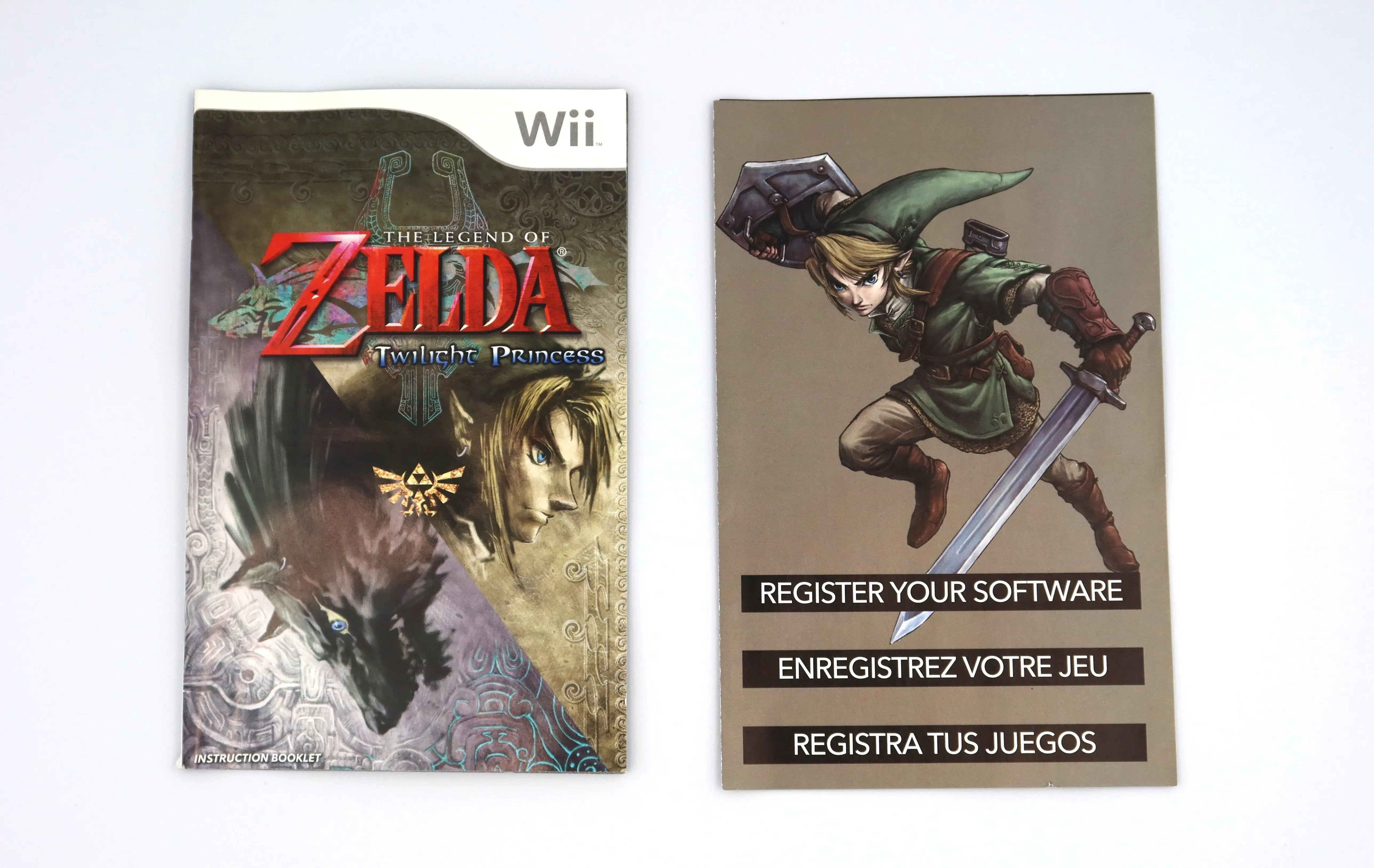 View of The Legend of Zelda Twilight Princess for Nintendo Wii inserts. Showcasing intact clean and authentic instruction booklet/manual and register your software insert on a clean white background.
